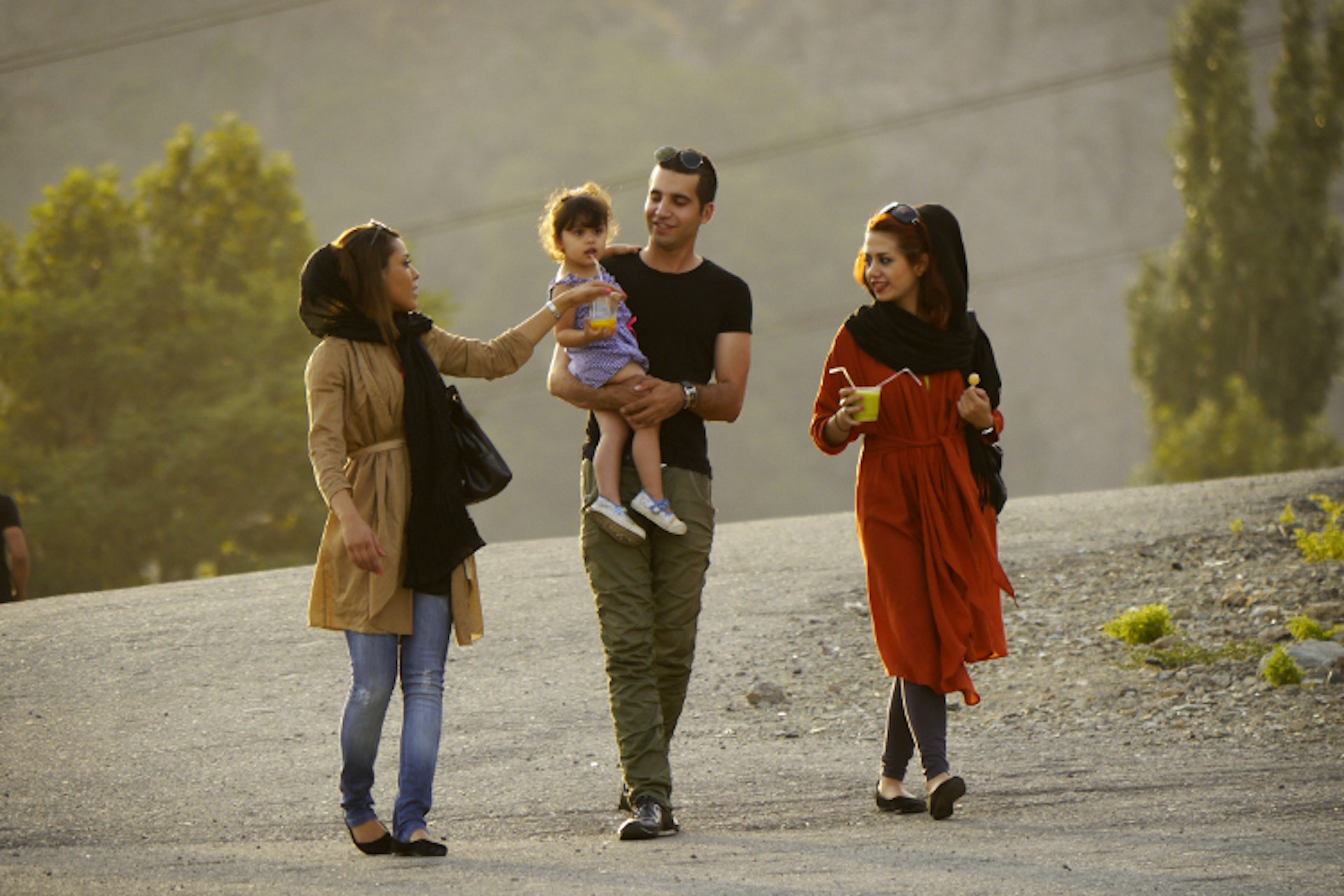 An Iranian family go for a stroll in Tehran. Image by Amos Chapple / Lonely Planet Images / Getty
