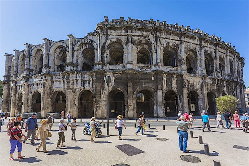 Features - nimes_cs Tourists outside the 1st-century Arènes de Nîmes. Image by Ken Welsh / Photolibrary / Getty Images