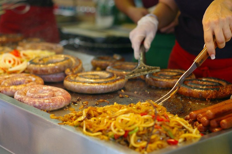Italian sausages sizzling at the San Gennaro Festival, Little Italy. Image by Adam Baker / CC BY 2.0