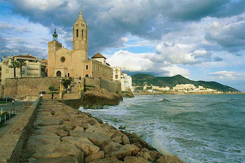 Features - sitges_cs The 17th-century Iglesia de Sant Bartomeu i Santa Tecla, Sitges. Image by Max Alexander / Dorling Kindersley / Getty Images