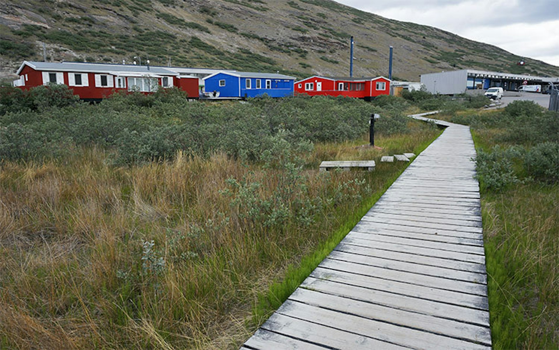 Brightly coloured buildings bring some Greenlandic charm to the remote town of Kangerlussuaq. Image by Anita Isalska / Lonely Planet