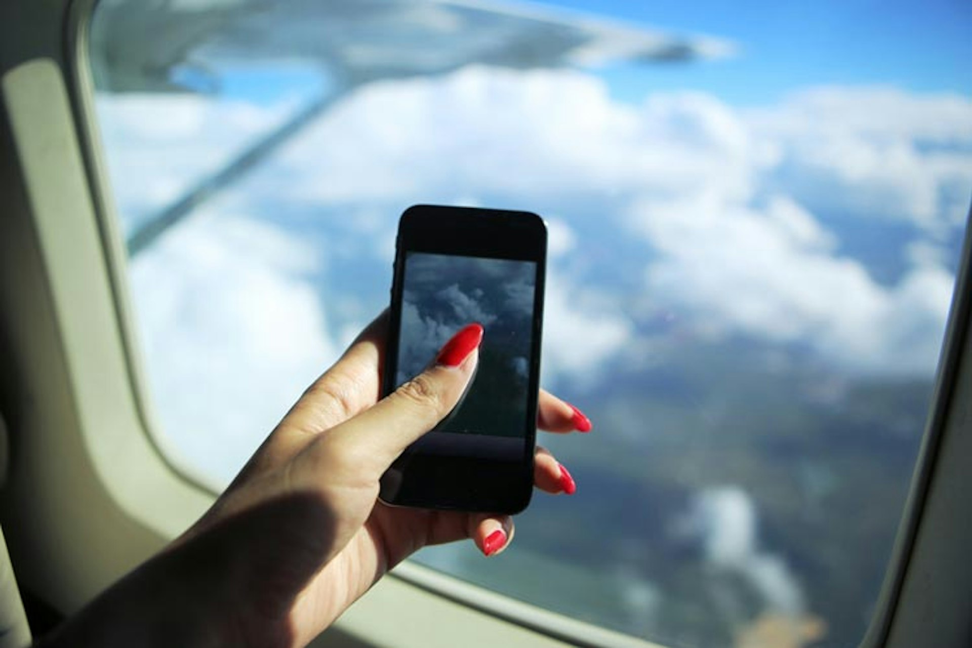 Snapping a mid-air Instagram picture is irresistible when you have travel planning and social sharing at your fingertips. Image by Photography by Bobi / Getty Images