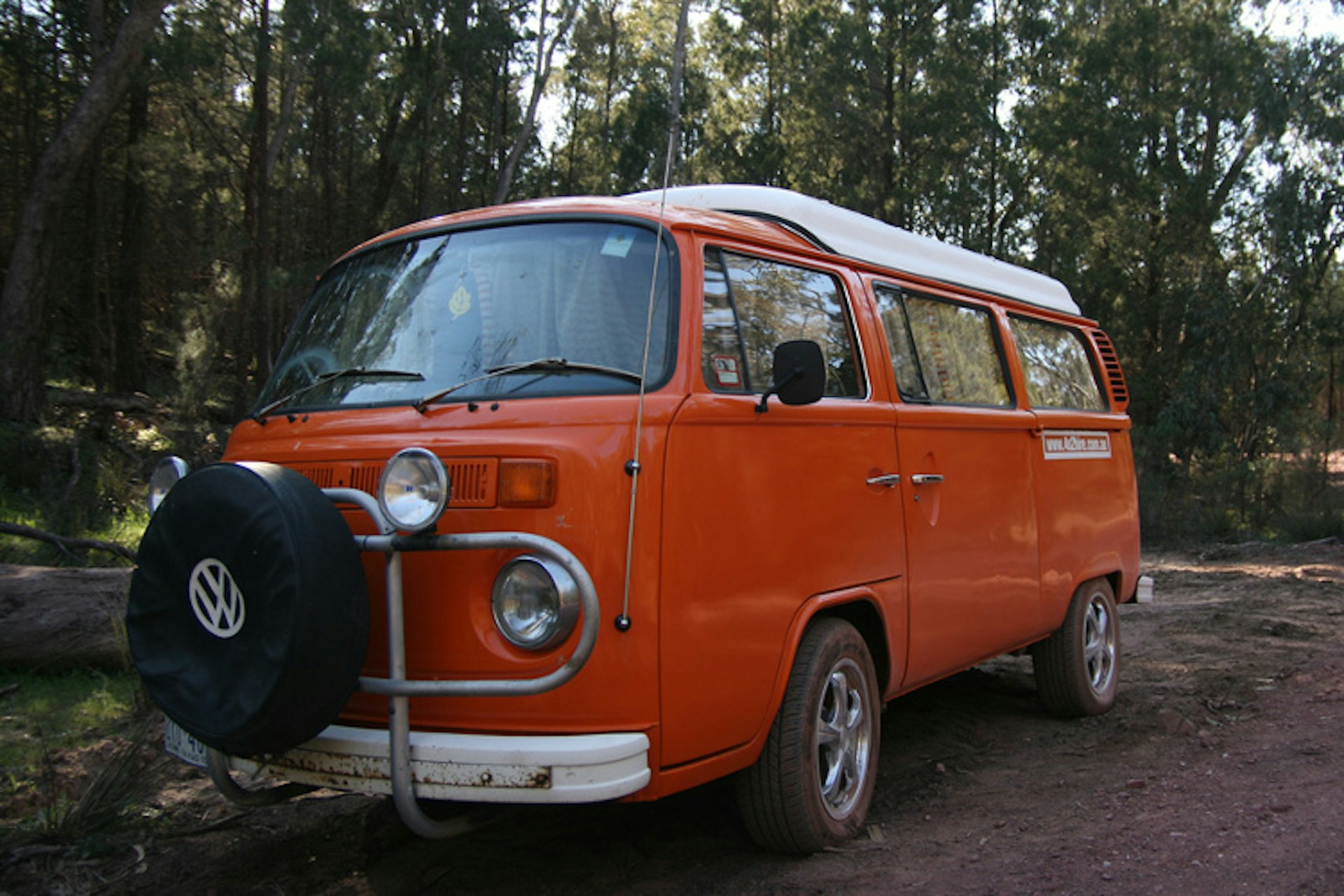 Orange VW Kombi van on a surfing road trip in Australia. Image by Hugh Lunnon / CC BY-SA 2.0