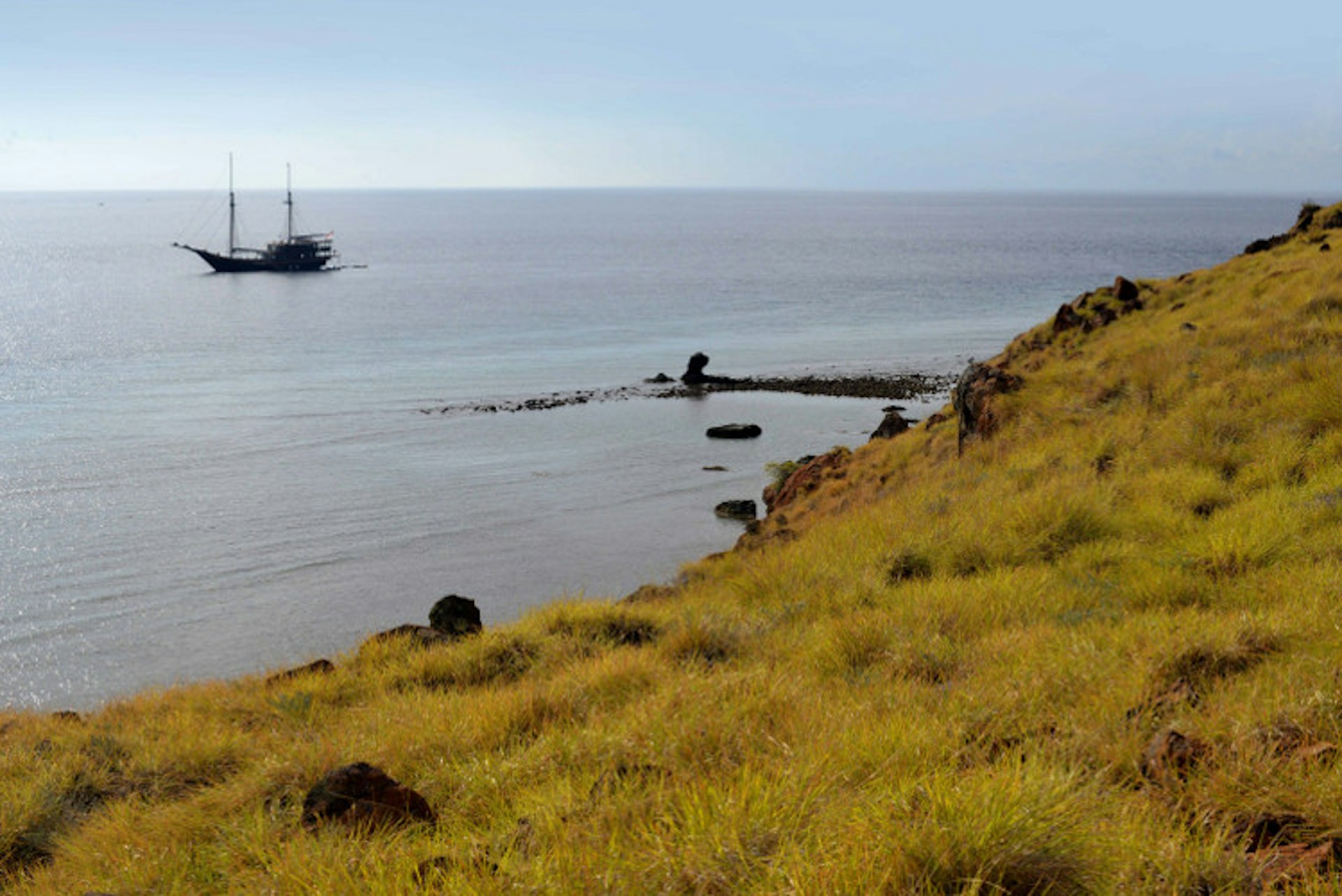 Dunia Baru anchored off a Komodo Island Islet. Image by Mark Eveleigh