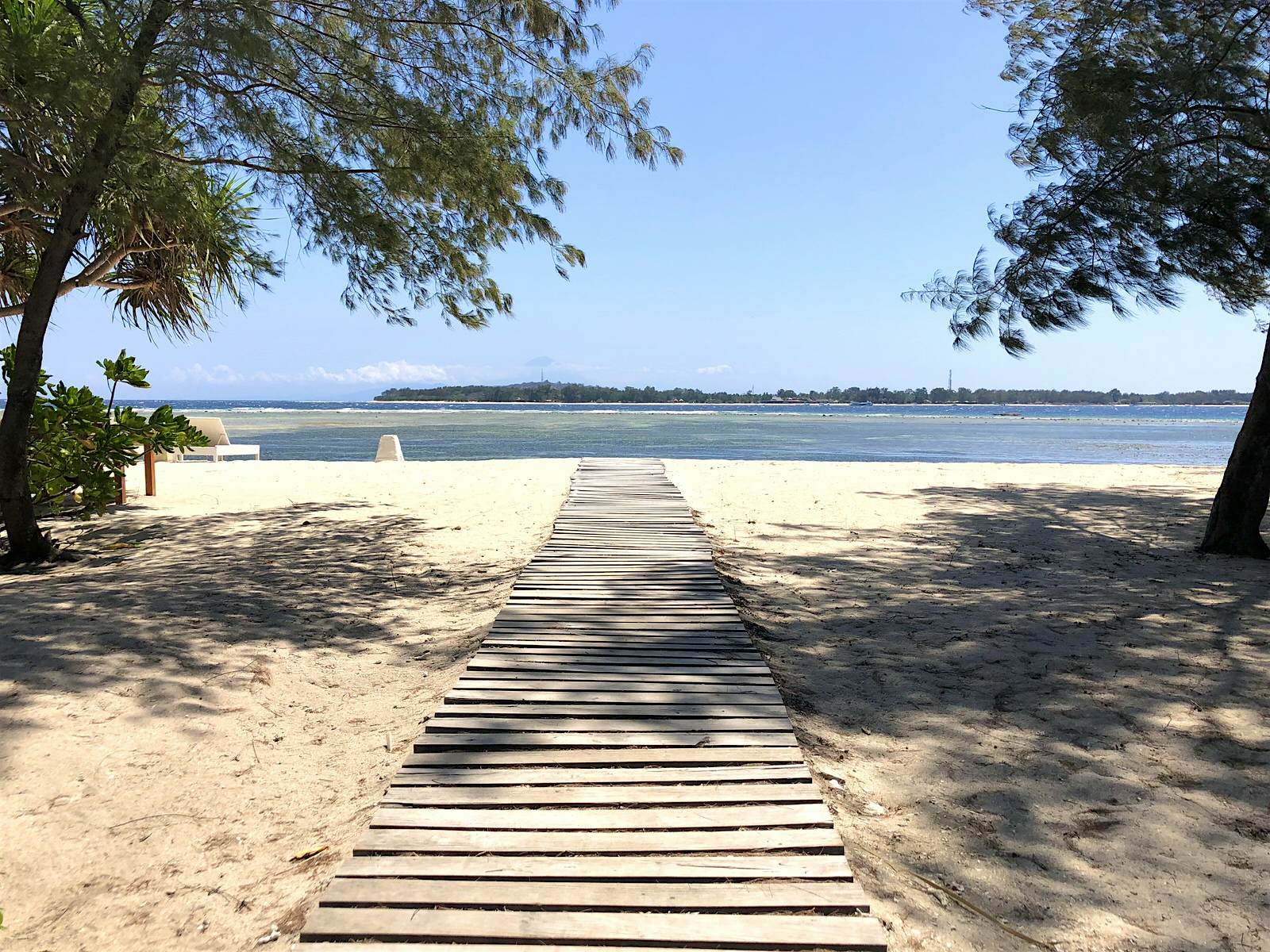 GIli Air beach A boardwalk leads down a white sand beach towards clear blue waters