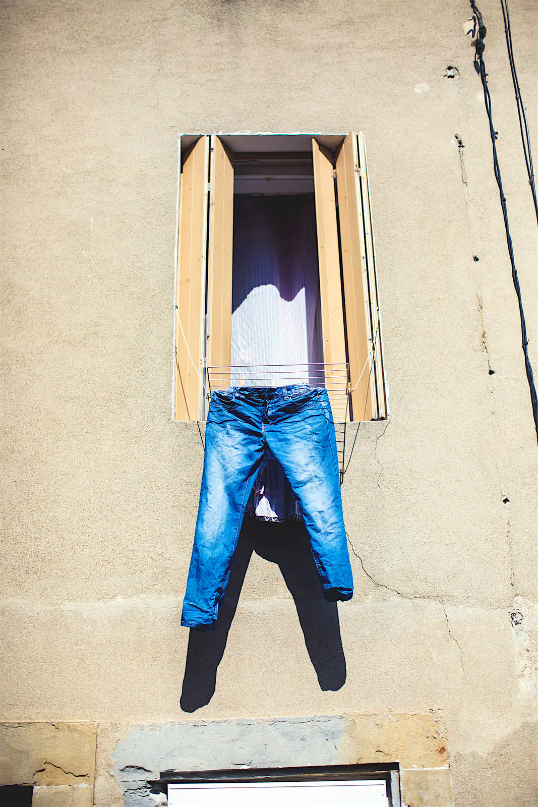 Features - Jeans hanging from open window, Boutenac, France It's not hard to sort out your laundry as you go © Lena Mirisola / Getty Images