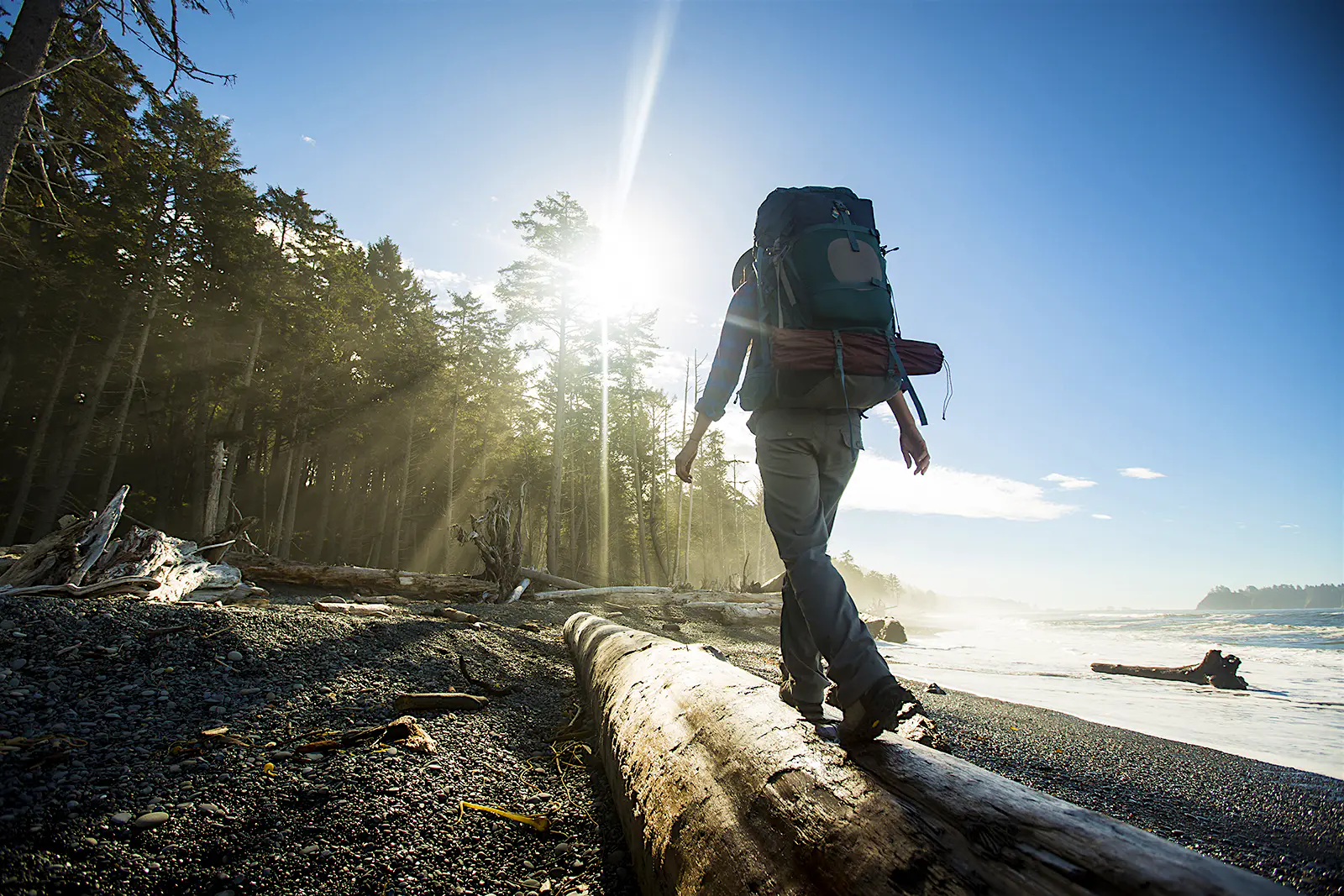 Features - Backpacking along a beach Take tough decisions at the start of the packing process to win your freedom on the road © Jordan Siemens / Getty Images