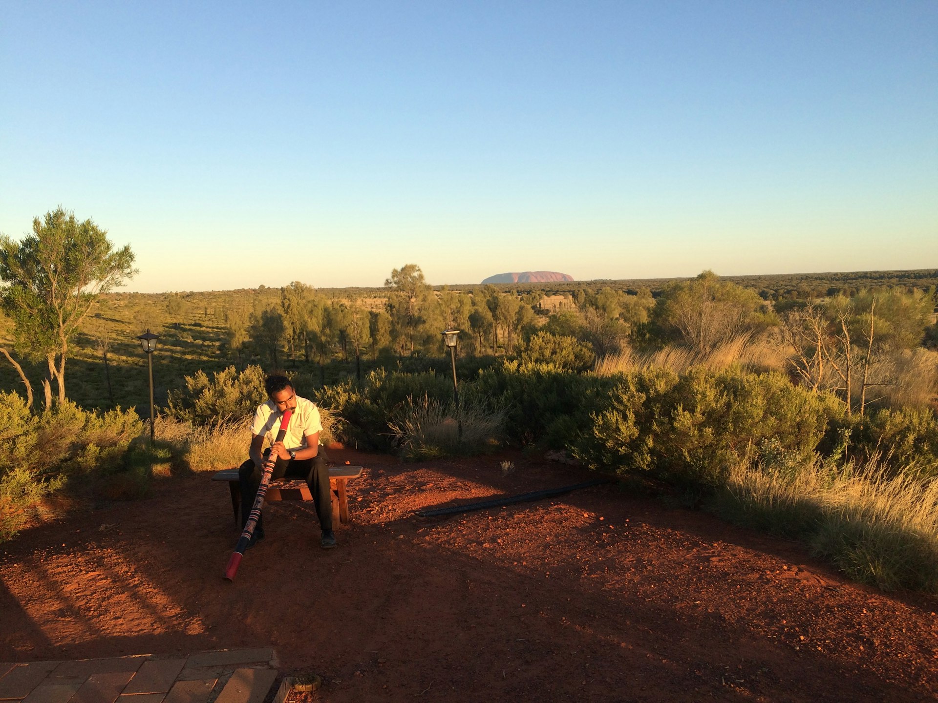 Aboriginal man, digeridoo near Uluru Australia