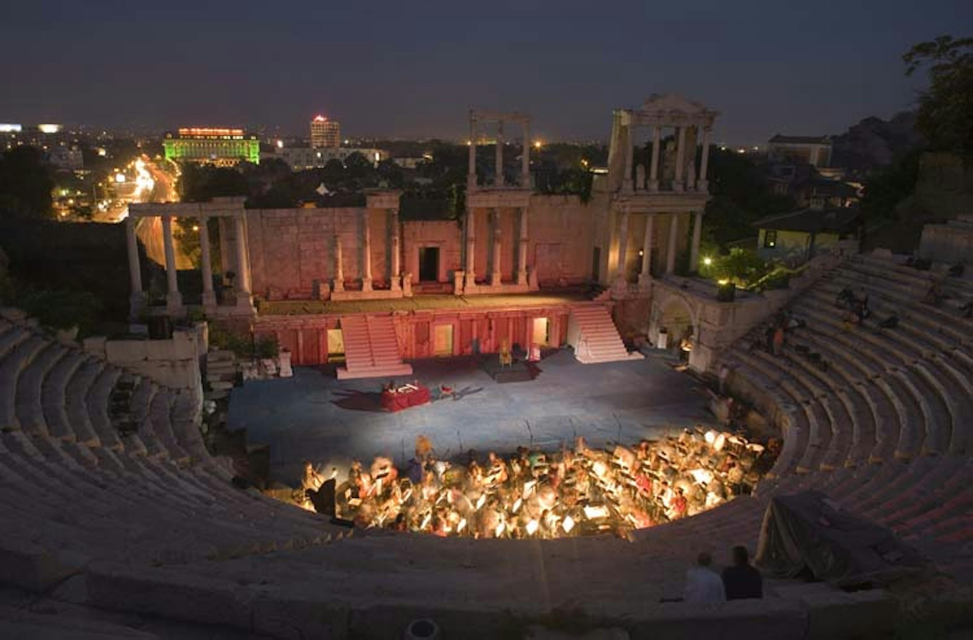 A performance lights up Plovdiv's amphitheatre as darkness falls. Image by De Agostini / W. Buss / Getty Images