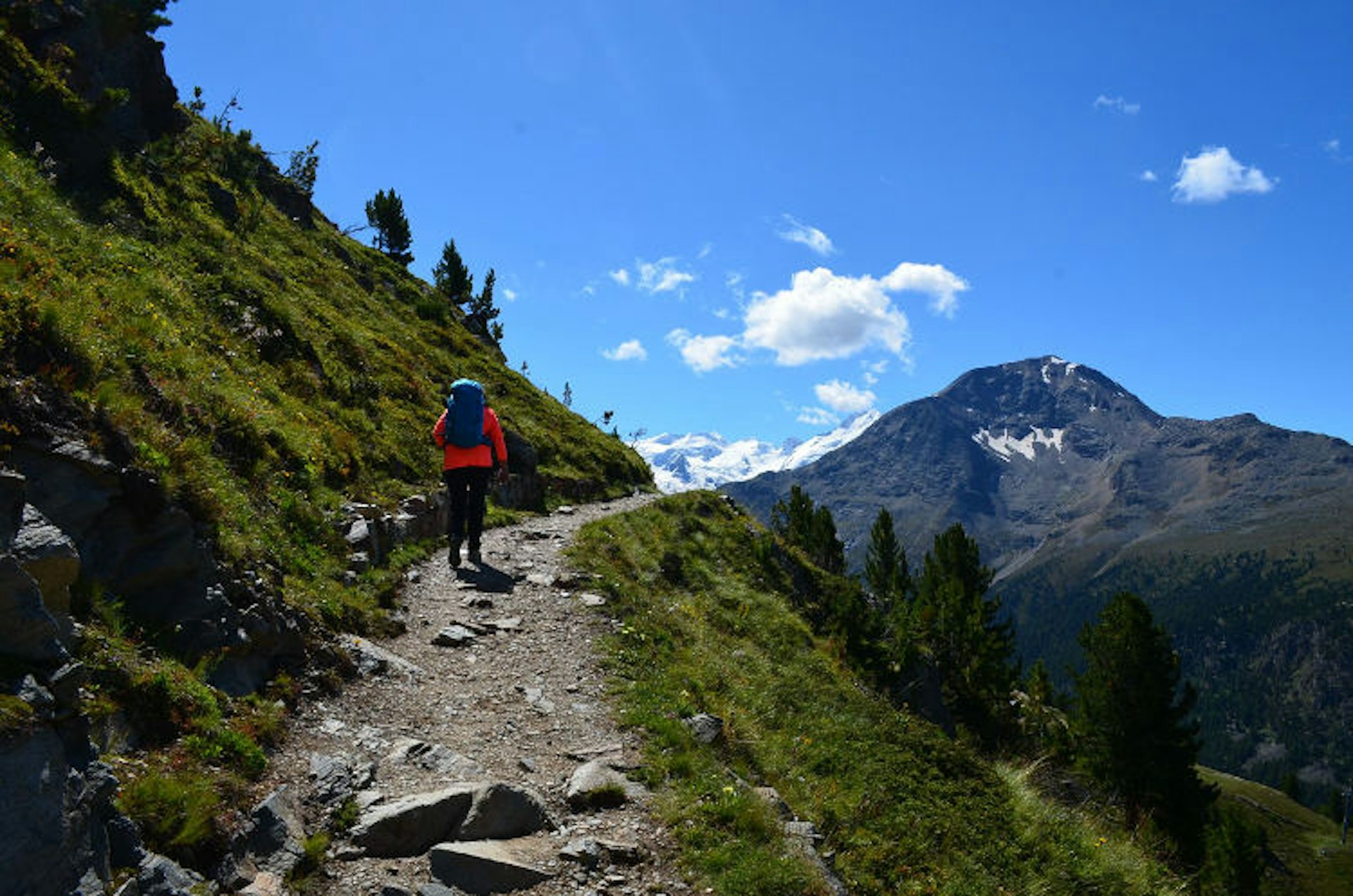 Summer hiking in the Swiss Alps with clear blue skies. Image by Kate Morgan/Lonely Planet