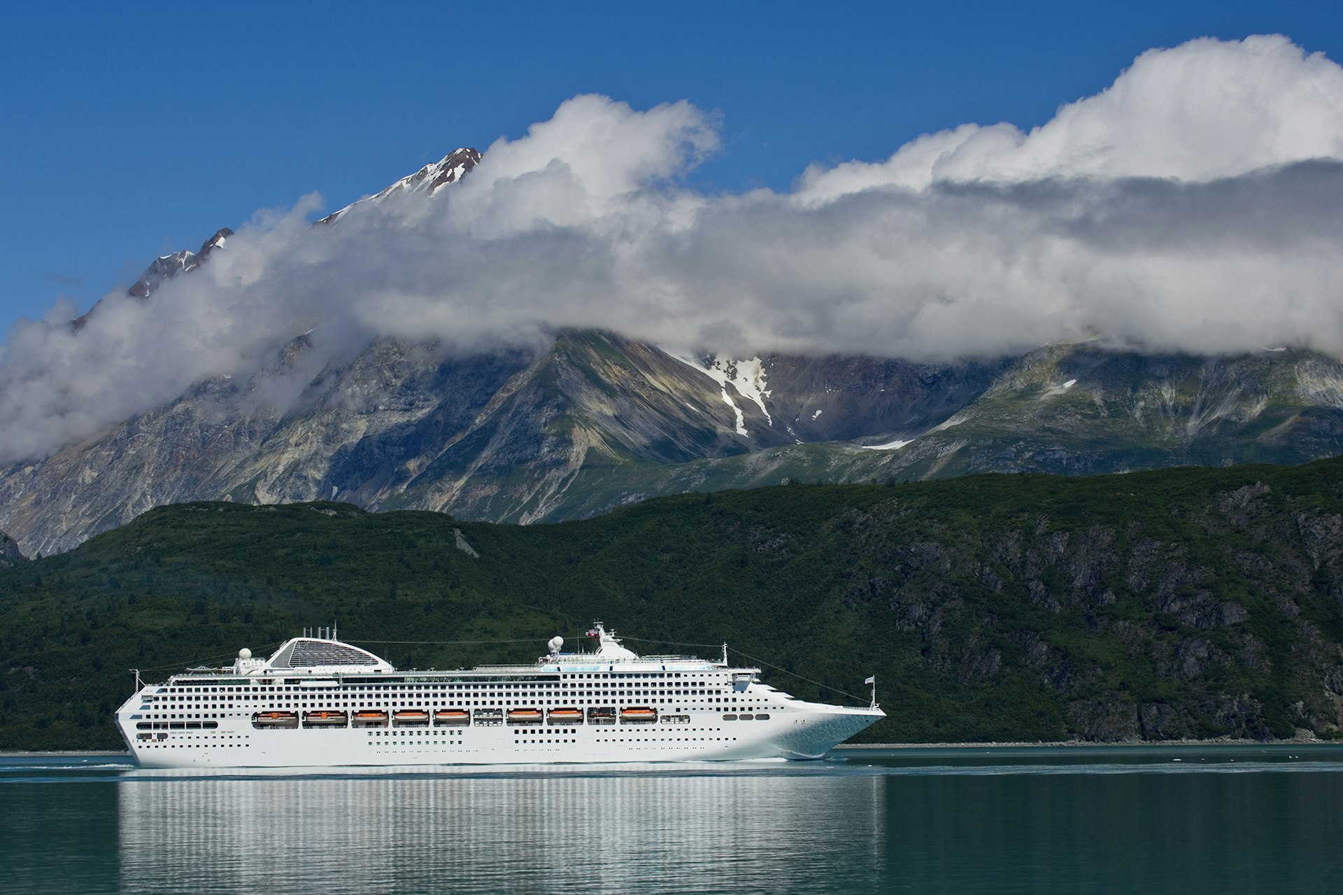 A cruise ship passes near Reid Glacier. Image by Michael Melford / The Image Bank / Getty