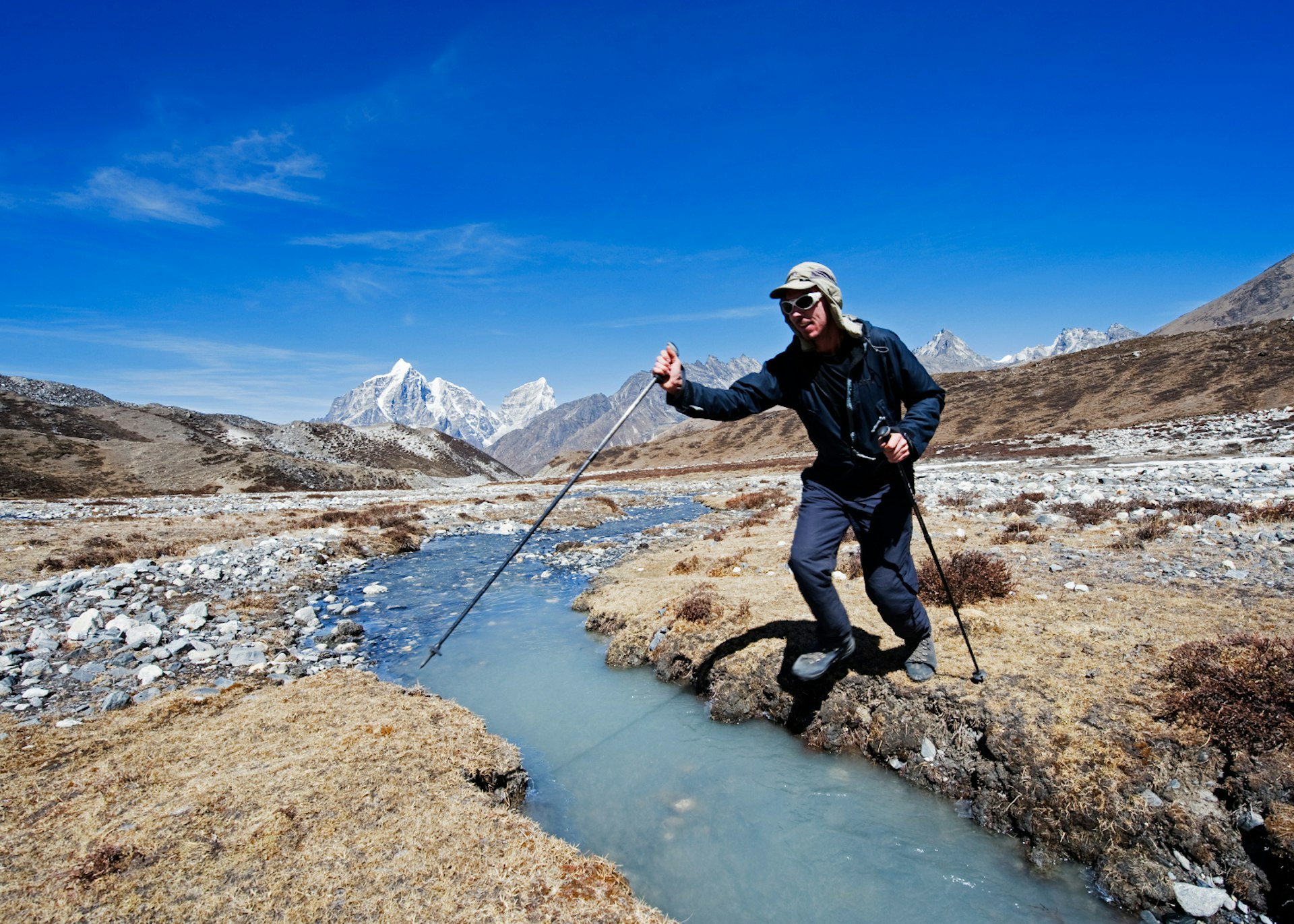 Crossing a stream in the Chukkung Valley. Image by Christian Kober / Getty Images.
