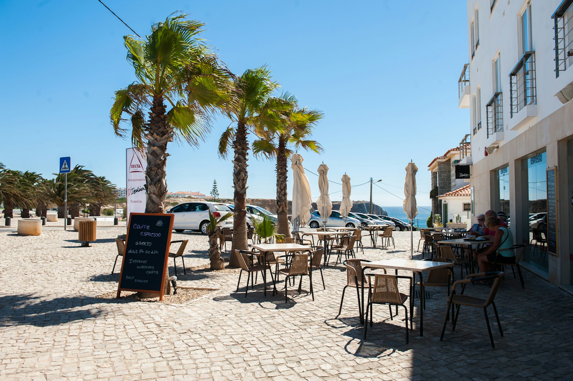 Seaside cafes in Sagres. Image by Lola Akinmade Åkerström / Lonely Planet