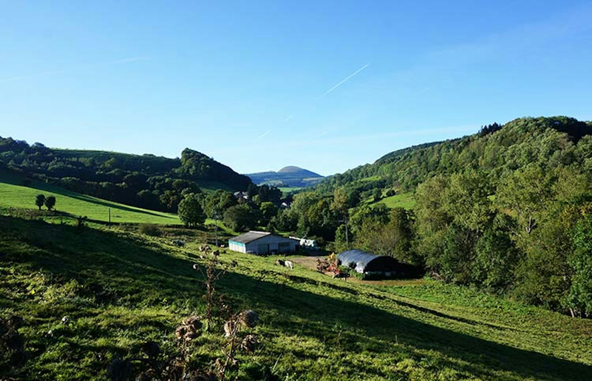 Orcival village in the Auvergne is tucked in among farmhouses and fields. Image by Anita Isalska / Lonely Planet