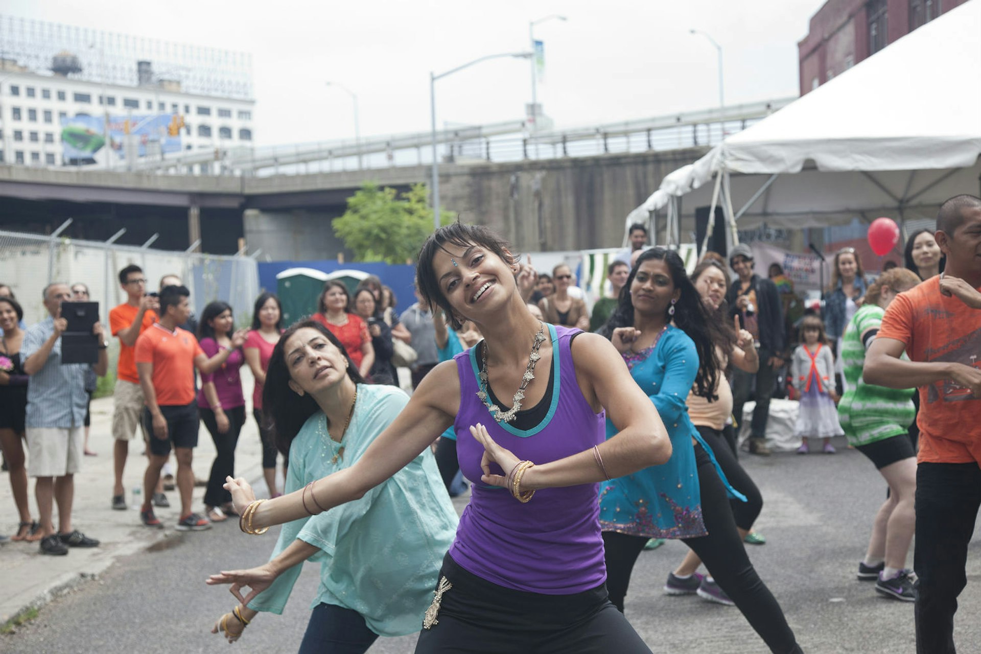 Bhangra dancing in the streets of Queens. Image courtesy of the Queens Tourism Council.