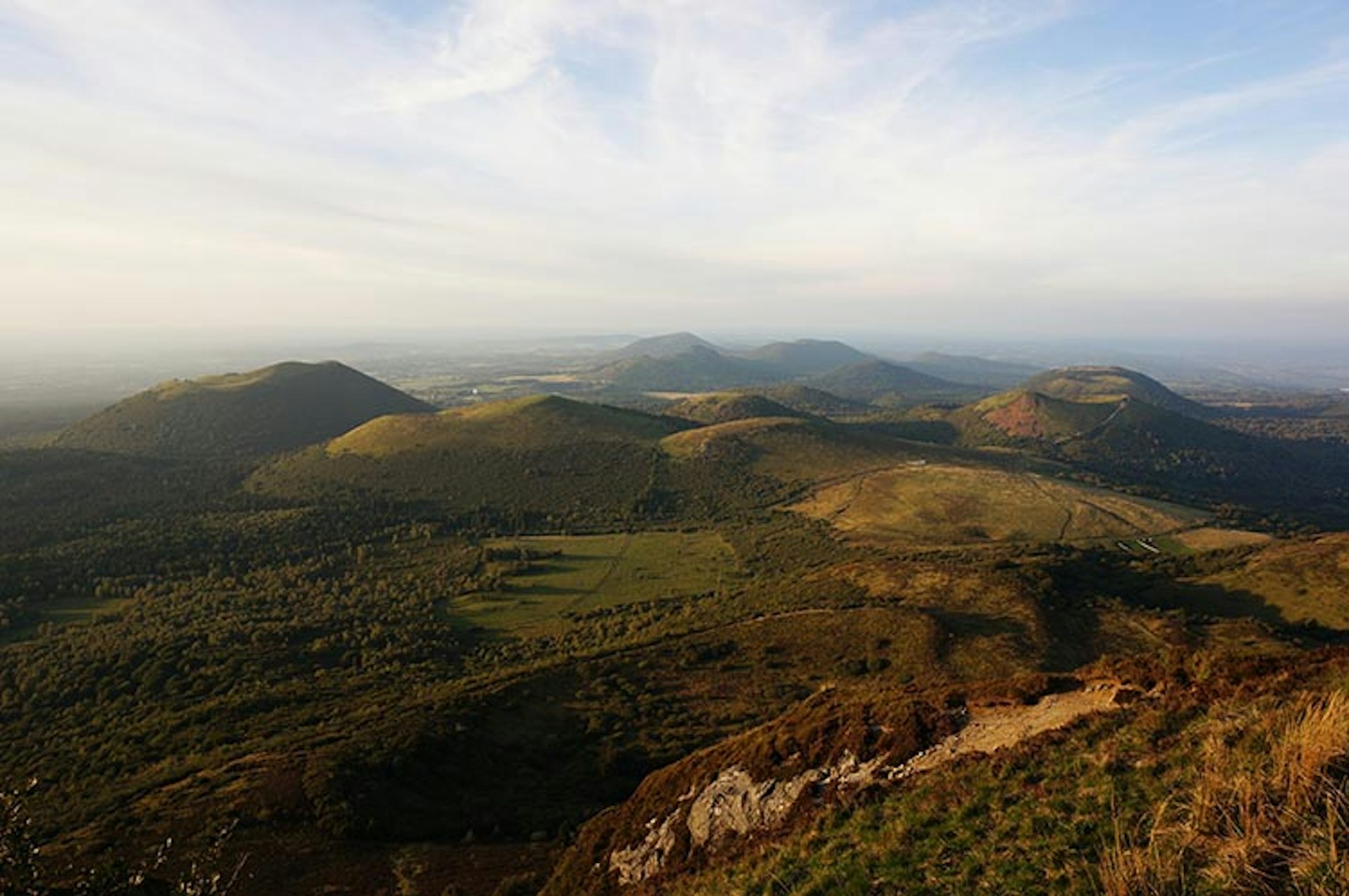 The dormant Chaîne des Puys volcanoes, seen here from the top of the Panoramique des Dômes, lend the Auvergne's scenery a dramatic quality. Image by Anita Isalska / Lonely Planet
