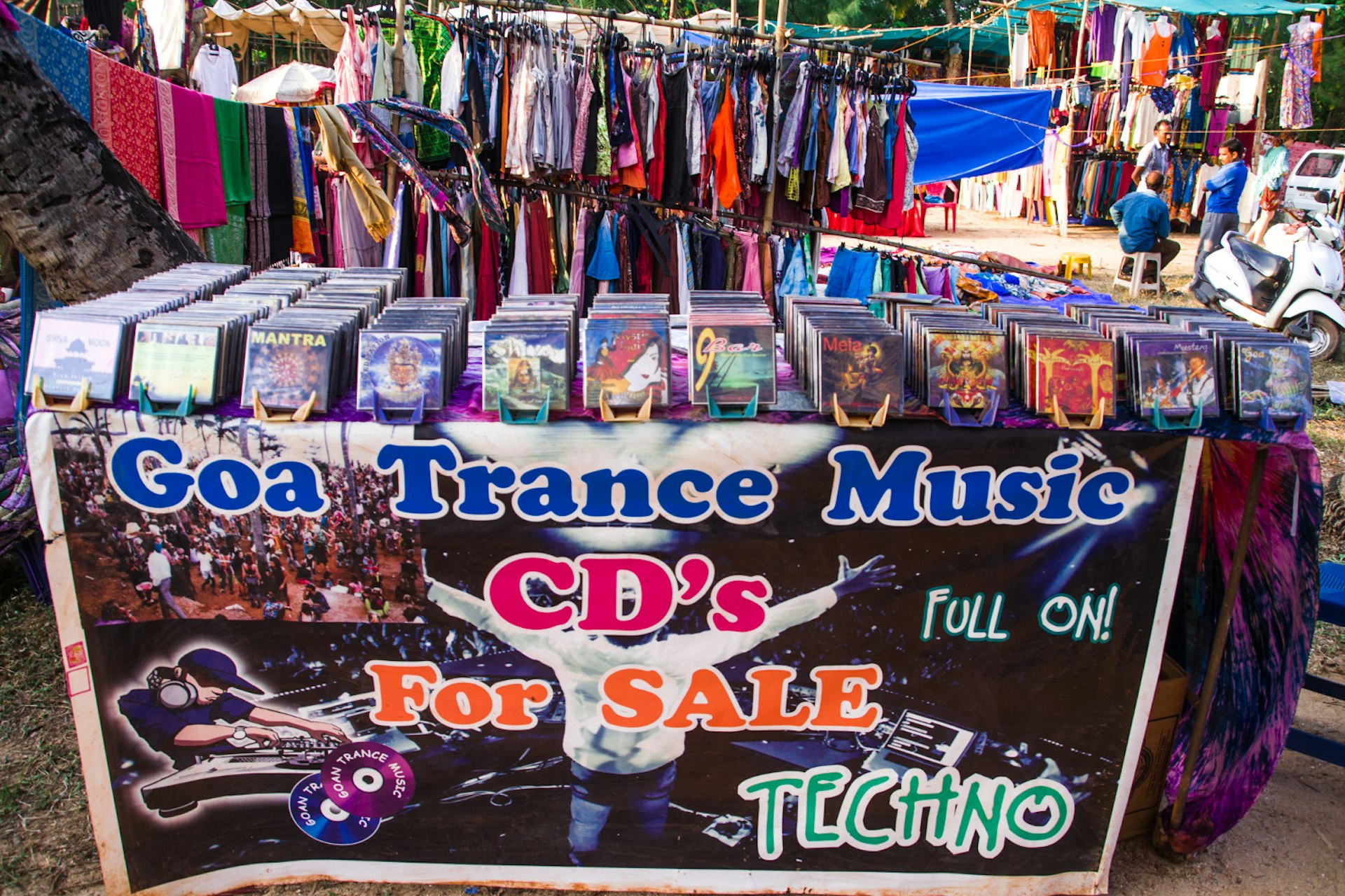 An array of trance CDs on sale at a market stall in Anjuna. The stall is a mishmash of psychedelic colours.