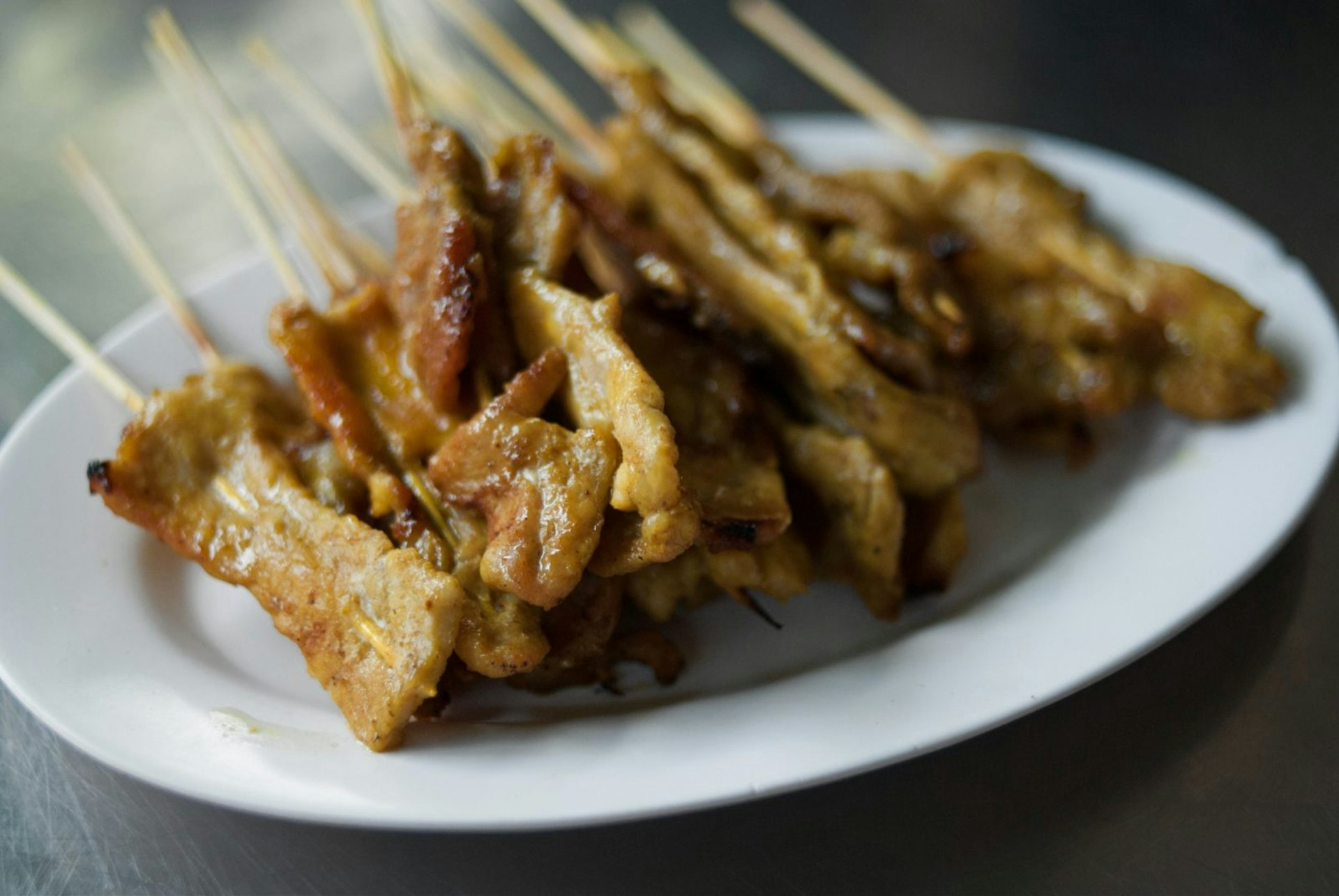 A plate of sate gai, chicken satay, Bangkok © Austin Bush / Lonely Planet