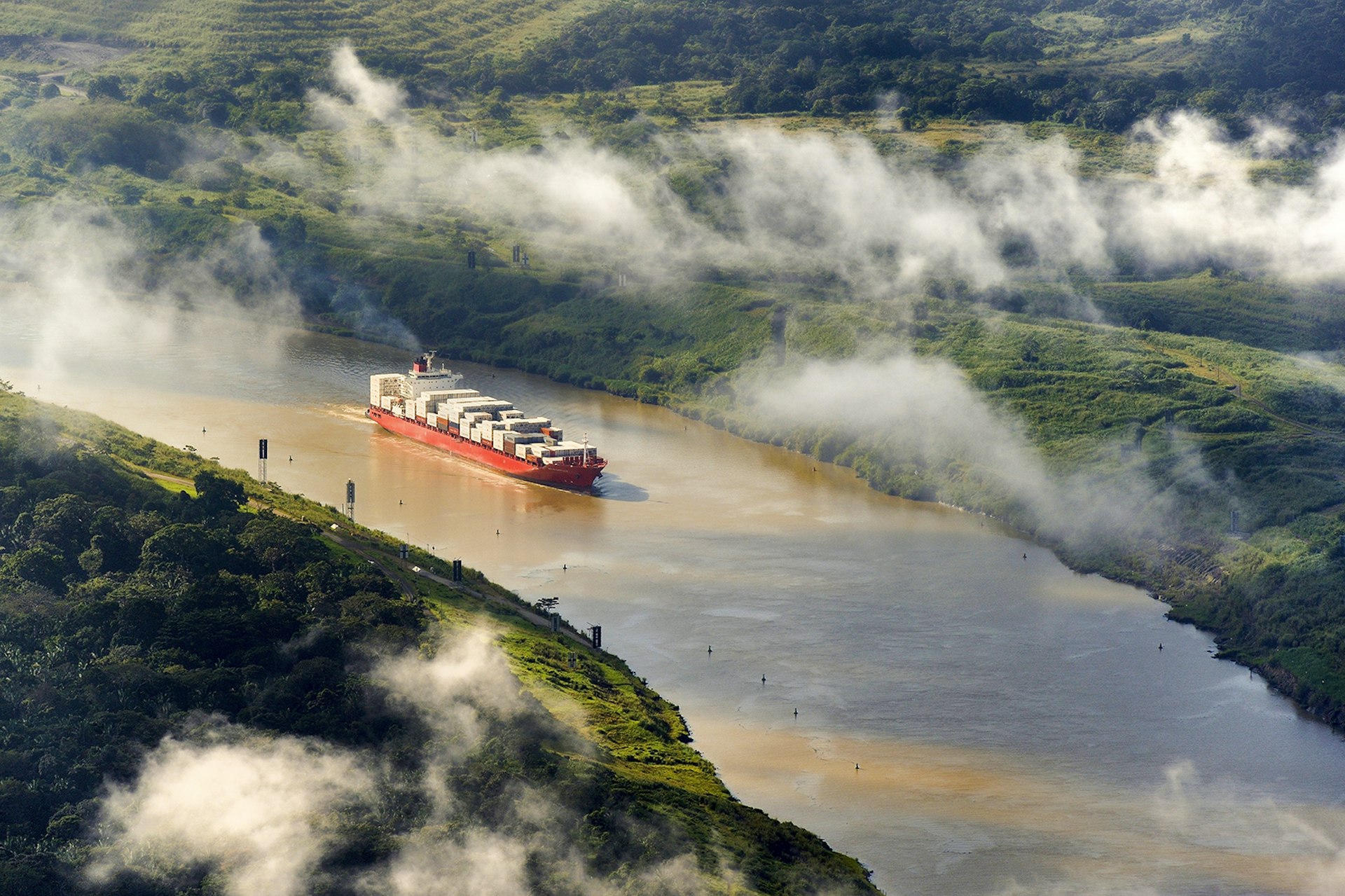 Features - Panama, Panama Canal, a Panamax container cargo uses the Gaillard cut (or Culebra cut) between the Pedro Miguel locks on the Pacific side and the Chagres river leading to Gatun Lake (aerial view)