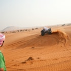 Features - An Middle Eastern Culture youth on a quad bike in the desert.