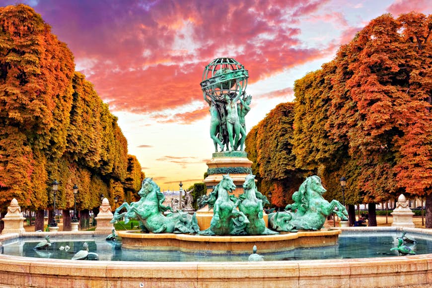 A statue inside the Jardin du Luxembourg at sunset