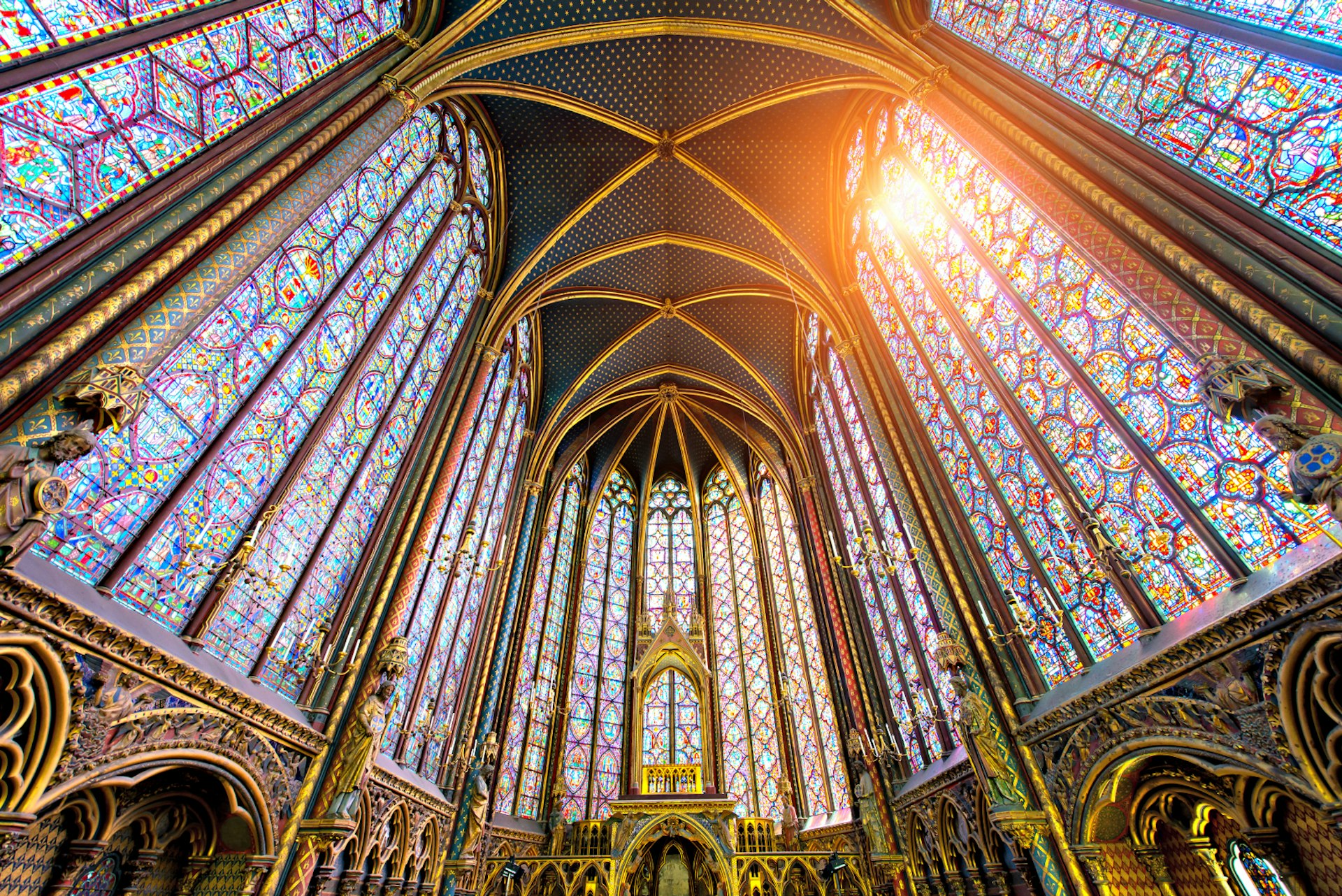 The sun streams through the stained glass windows of Sainte-Chapelle, Paris