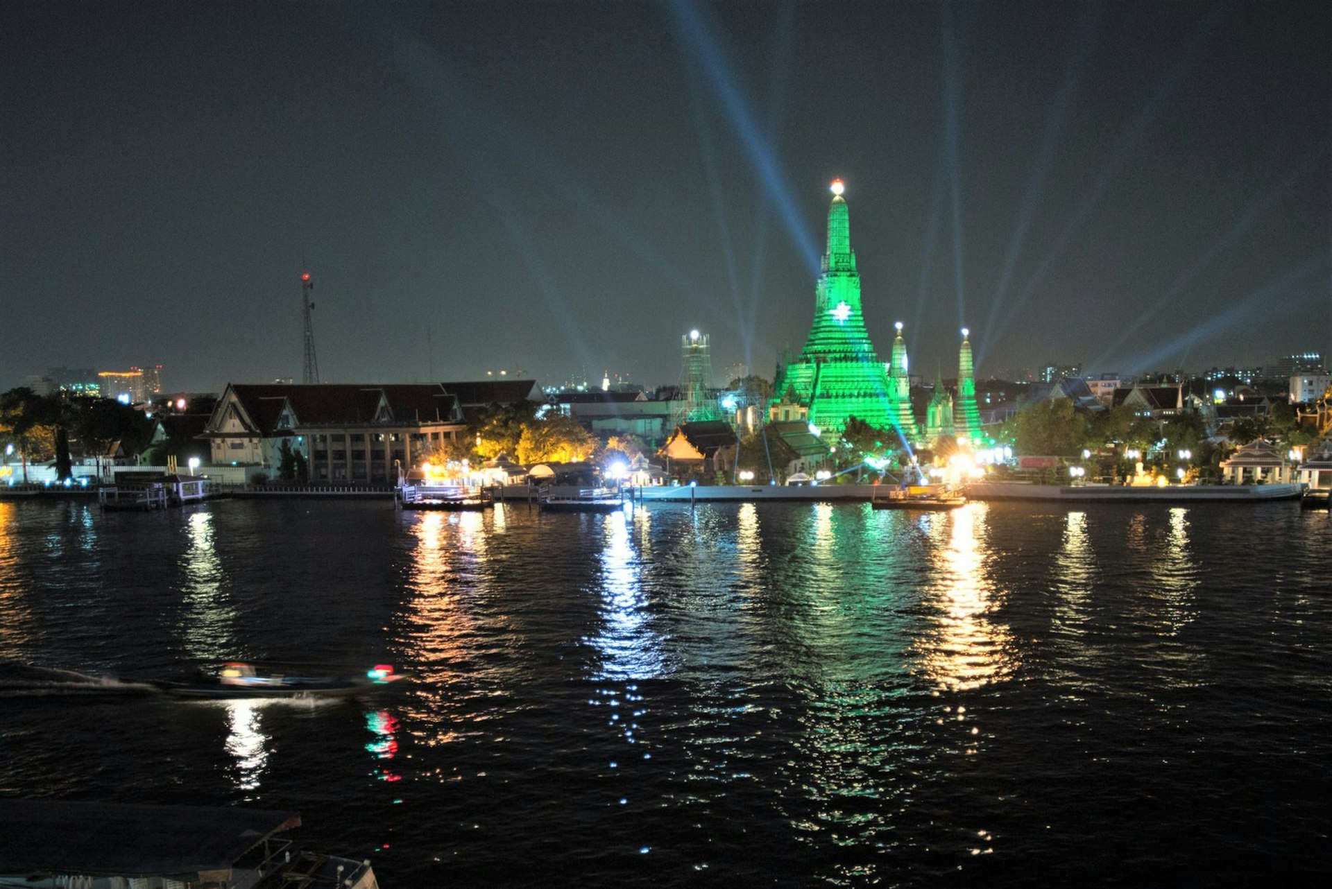 Night view of Wat Arun, illuminated green, looking across the river from the Roof bar © Austin Bush / Lonely Planet