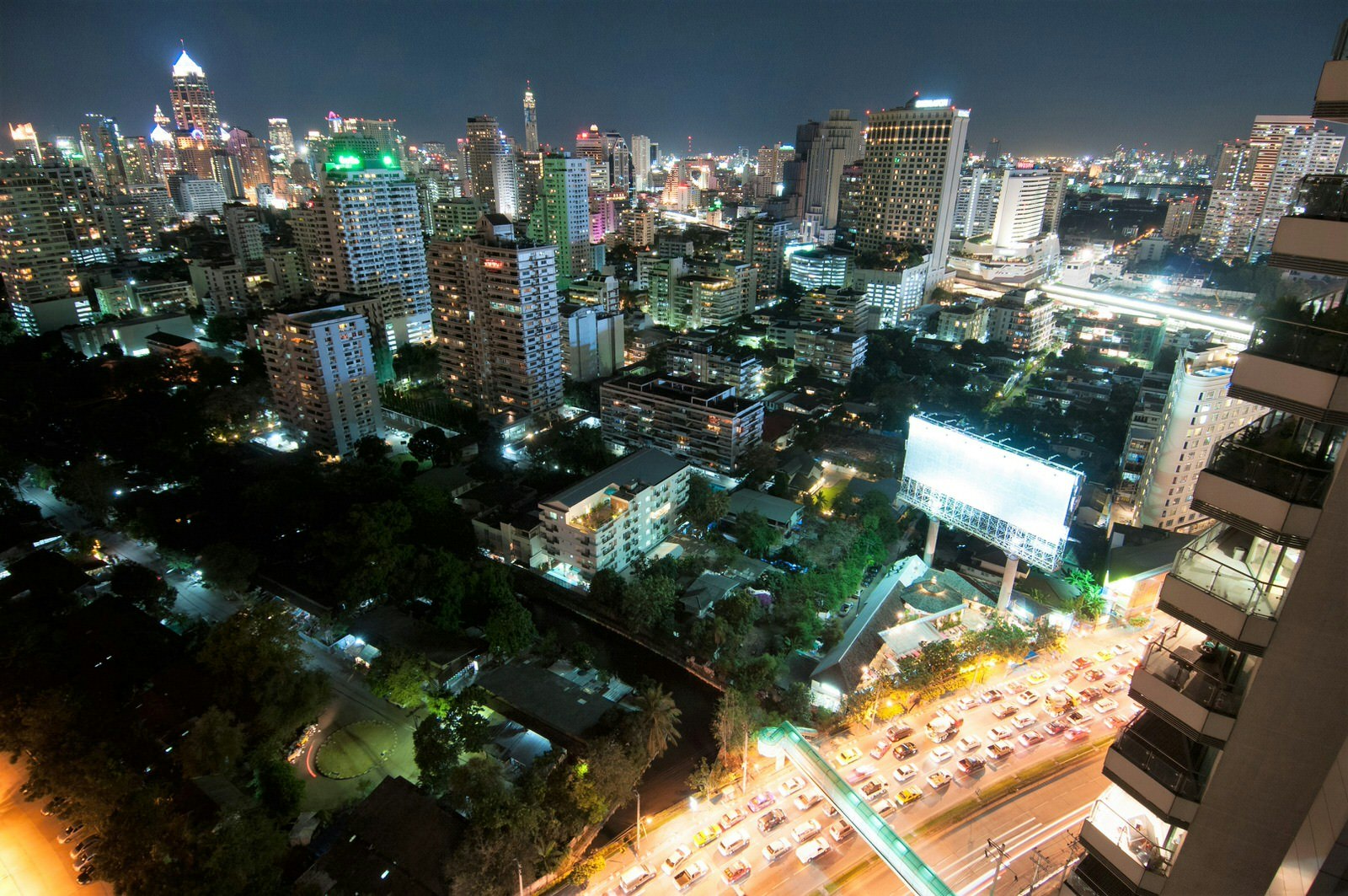 High view of busy Asoke intersection as seen from Long Table at night © Austin Bush / Lonely Planet