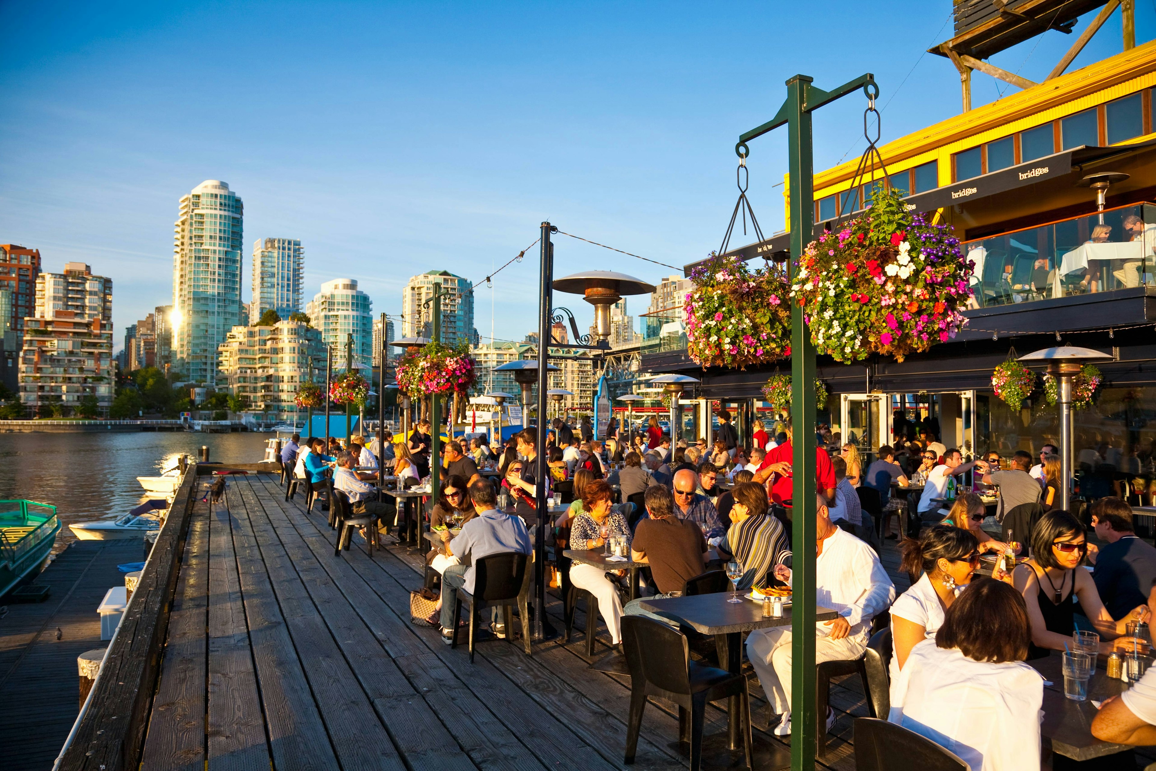 Alfresco dining on Granville Island, with Vancouver in the background. Image by Stuart Dee / The Image Bank / Getty