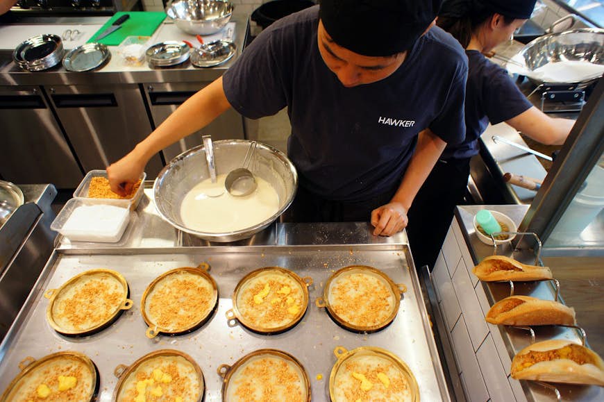 Malaysian apam balik (crispy turnover pancakes) being freshly made at Hawker in Sydney. Image by Phillip Tang / Lonely Planet