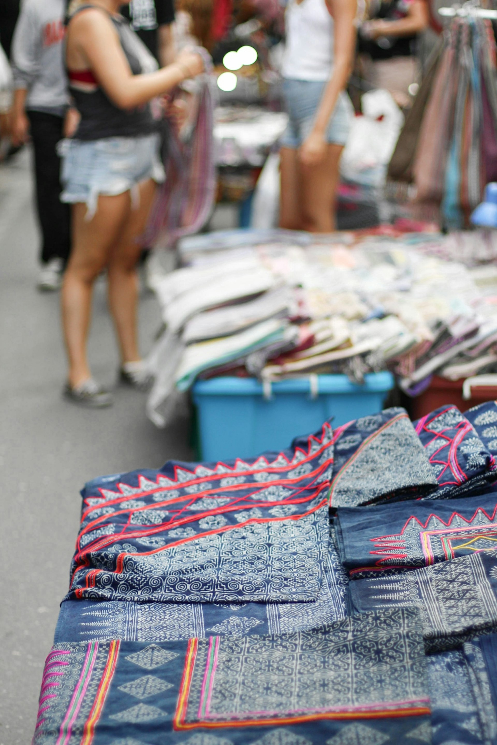 Thai textiles on display at the Sunday Walking Street Market in Chiang Mai, Thailand © Alana Morgan / Lonely Planet