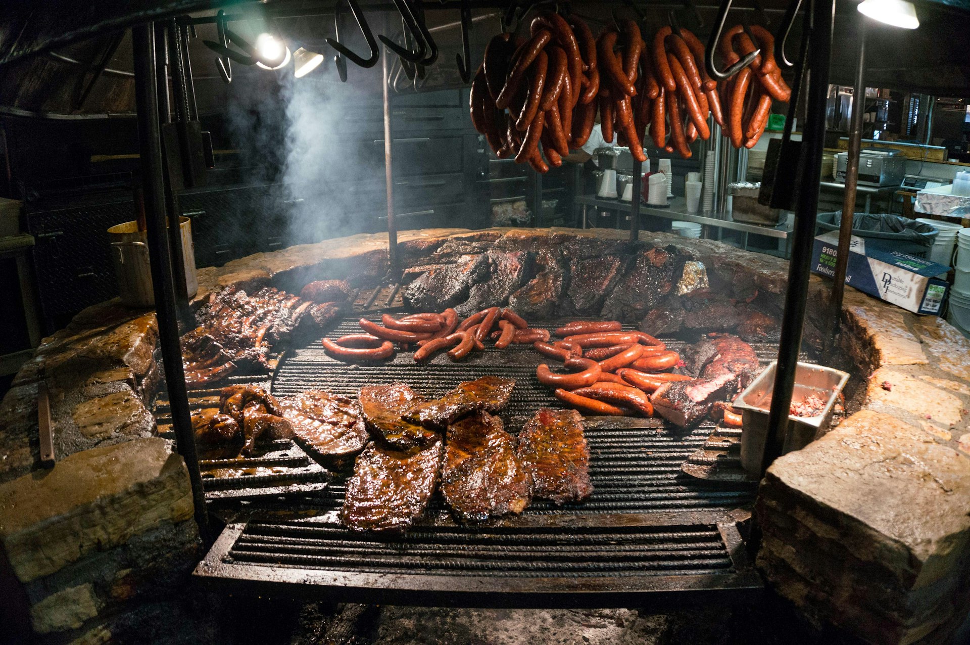 A variety of meats being prepared on The Salt Lick’s barbecue. Image by Anthony Quintano / CC BY 2.0