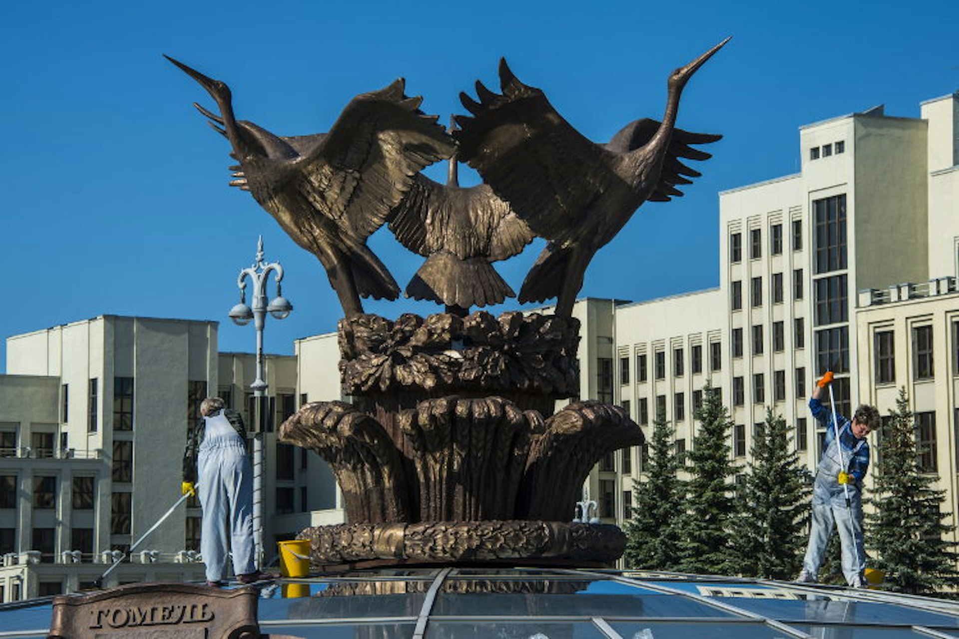 Woman cleaning a giant bird statue on top of a glass cupola on Nezalezhnasti Independence square, Minsk. Image by Michael Runkel / Robert Harding World Imagery / Getty Images 