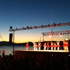 The whole town turns out for a children’s harbourside ballet performance in Hydra. Image by Alexis Averbuck / Lonely Planet