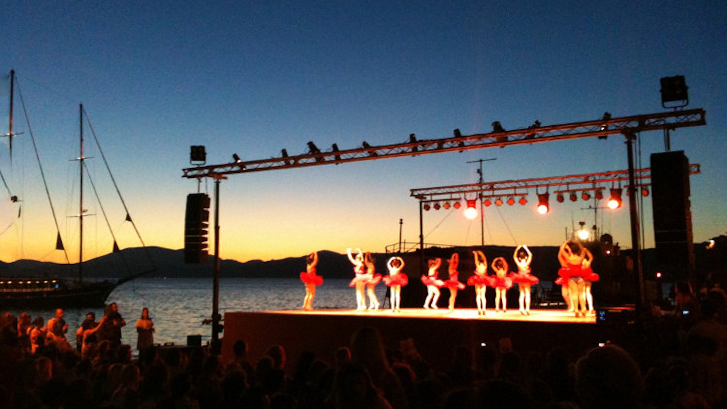 The whole town turns out for a children’s harbourside ballet performance in Hydra. Image by Alexis Averbuck / Lonely Planet