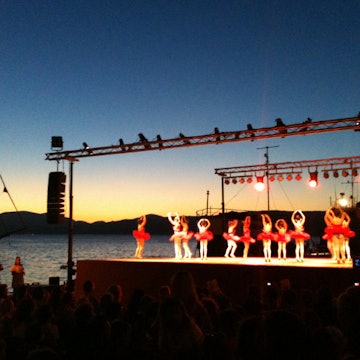 The whole town turns out for a children’s harbourside ballet performance in Hydra. Image by Alexis Averbuck / Lonely Planet