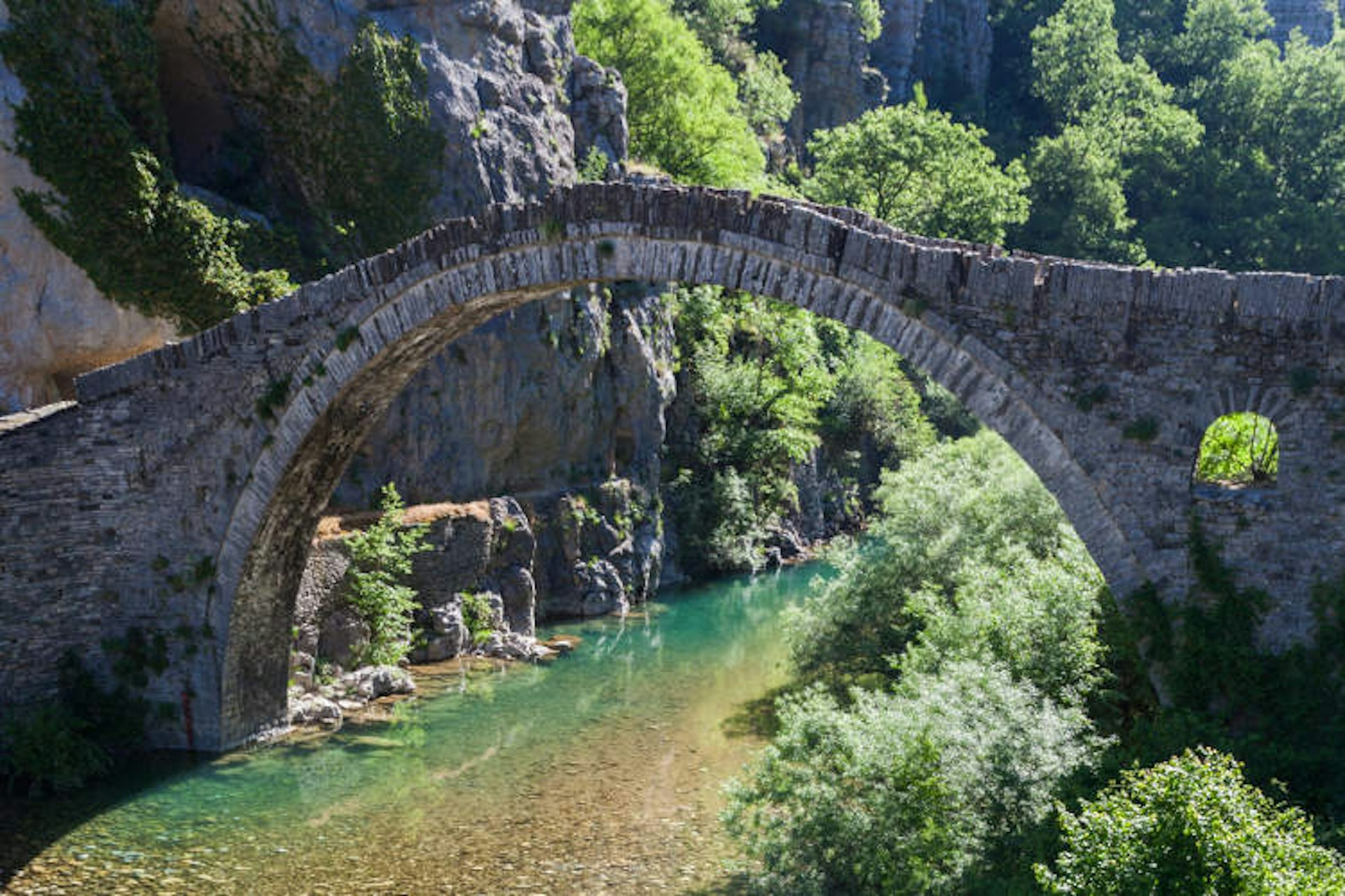 Ottoman arched bridge over Voidomatis River, Vikos Gorge. Image by Danita Delimont / Getty Images