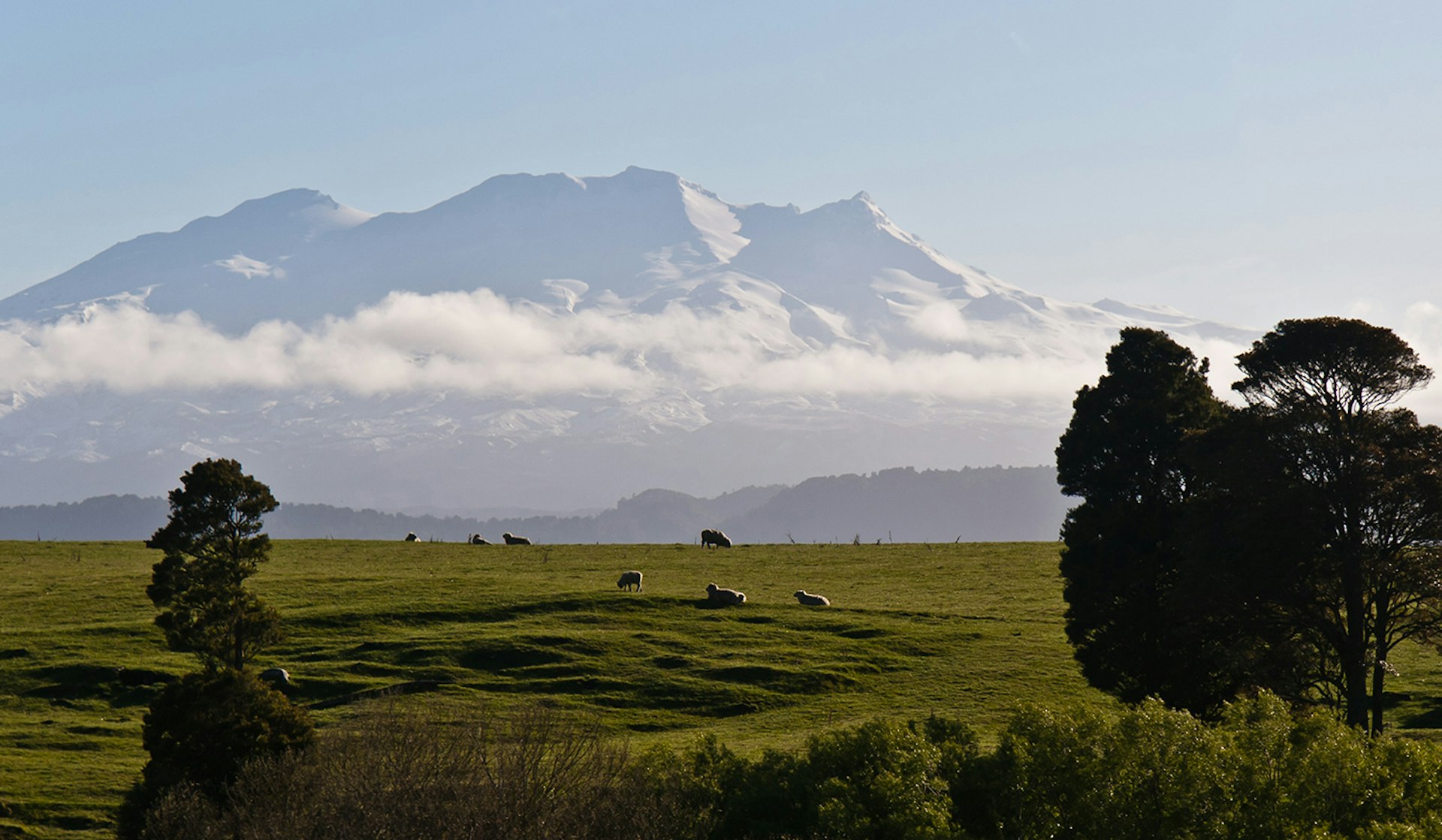 The striking silhouette of Mount Ruapehu rising from the clouds might make it hard to fix your eyes on the road. Image by Jason Pratt / CC BY 2.0