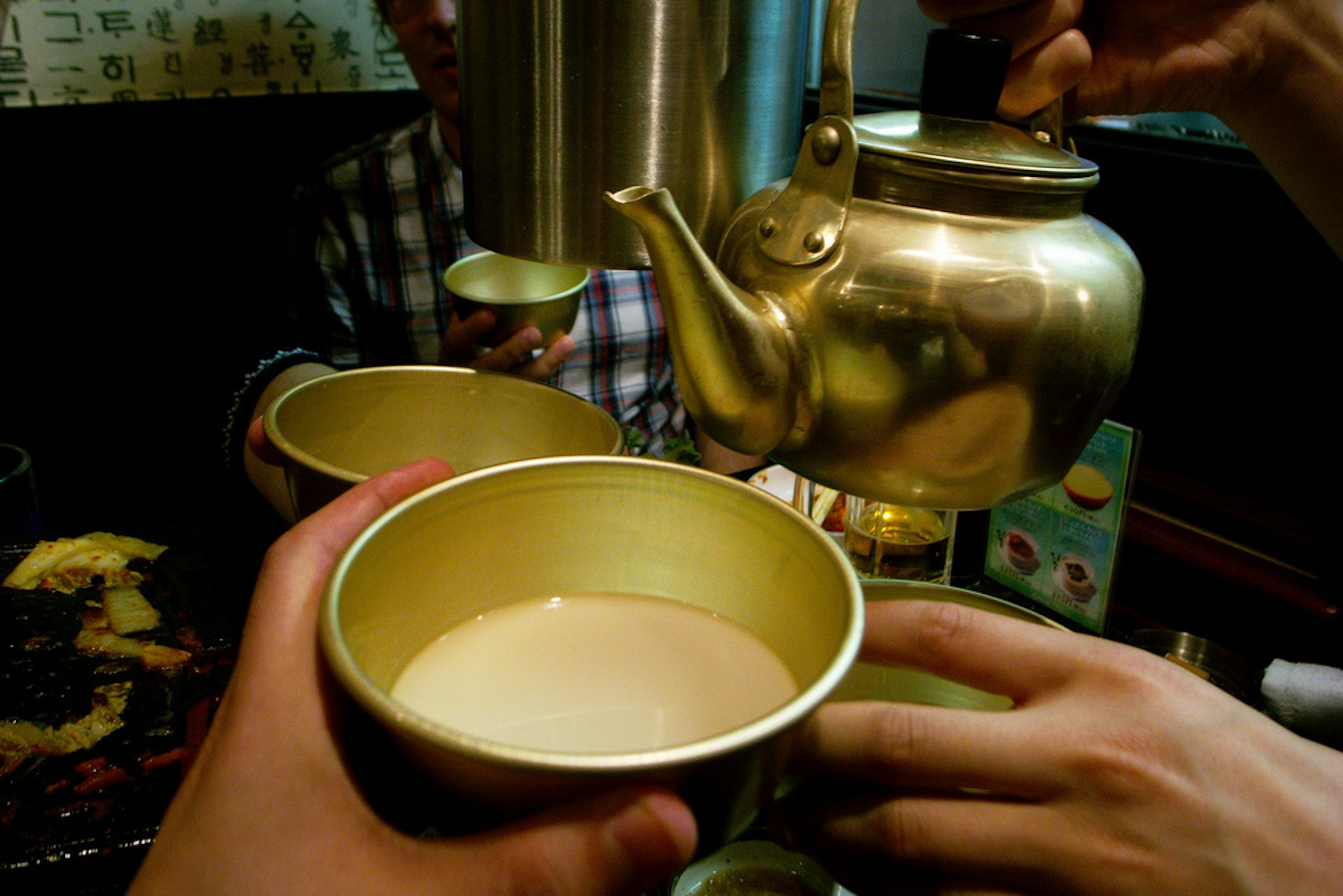 Makgeolli is served from copper kettles. Image by Jon Åslund / CC BY 2.0