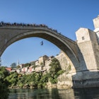Jumping from Mostar's Stari Most. Image by Tim E White / Getty