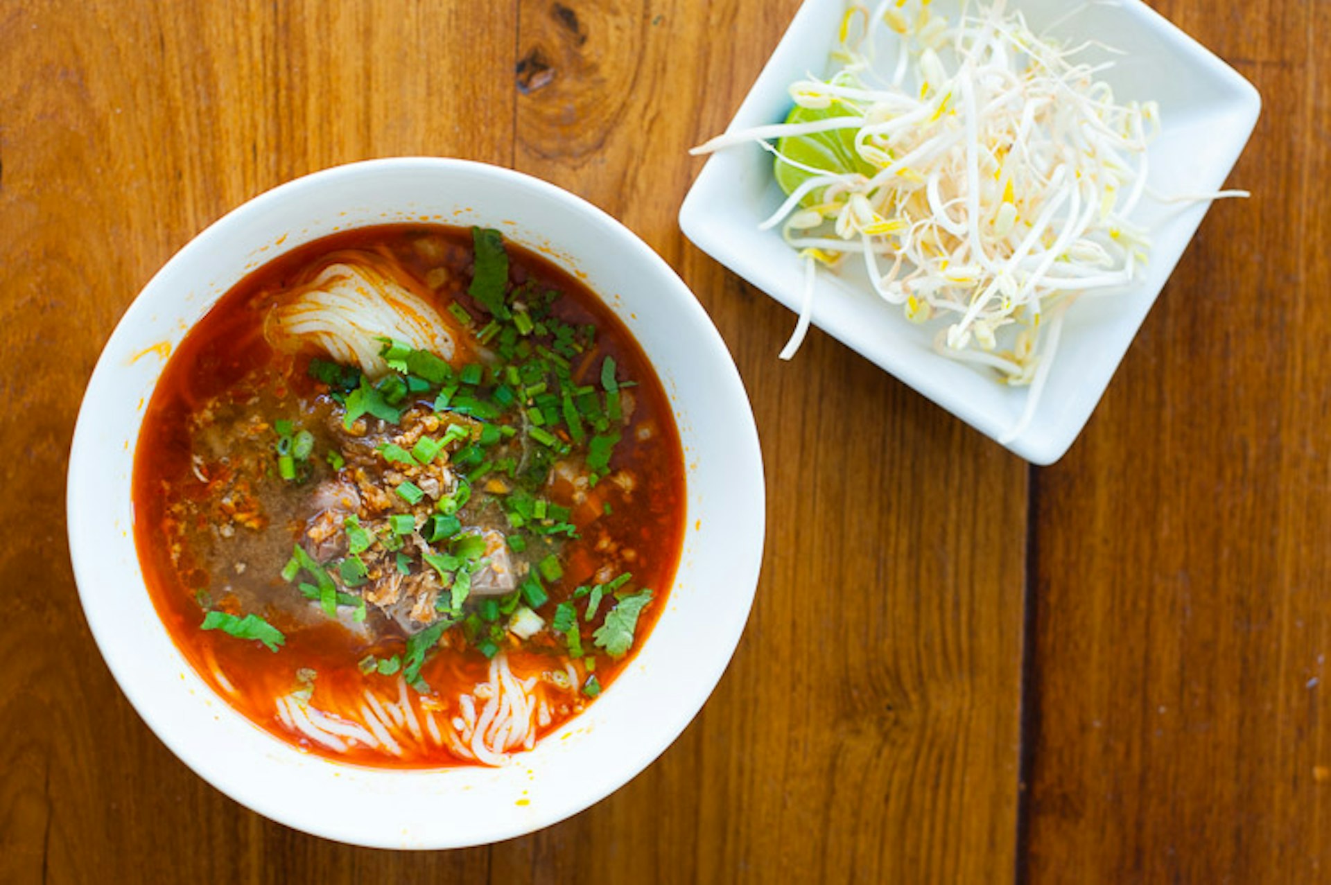 Kà•nŏm jeen nám ngée•o as served at a stall in northern Thailand. Image by Austin Bush