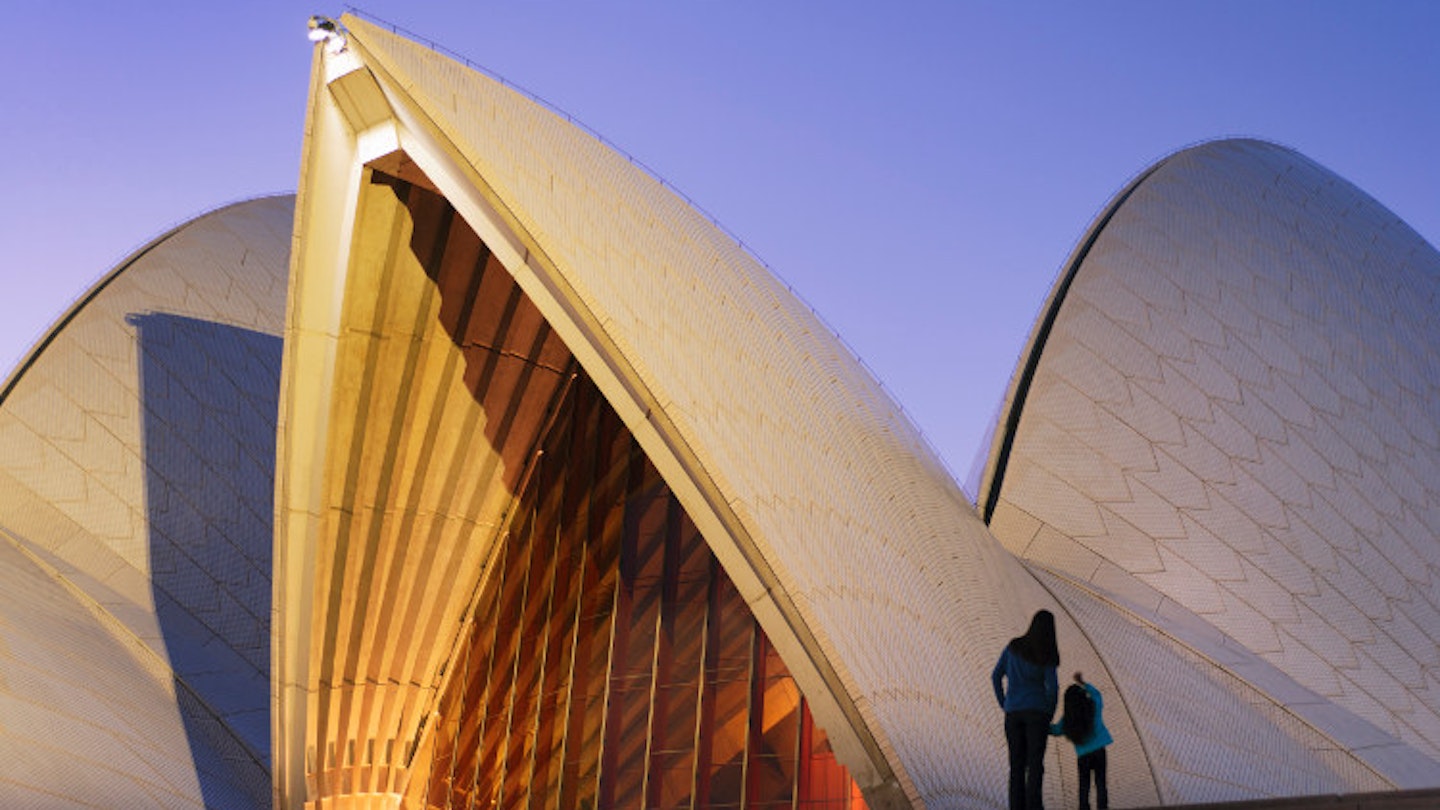 Admiring the Sydney Opera House at dusk. Image by Shaun Egan / Getty Images