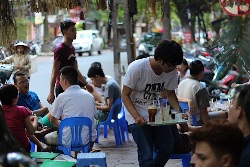 People drinking outside a cafe in Hanoi
