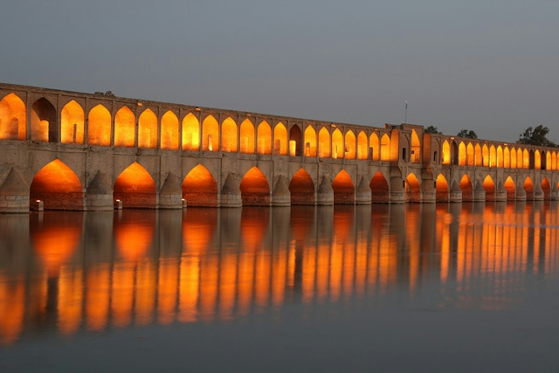 Esfahan's Si-o-Seh Bridge illuminated at dusk