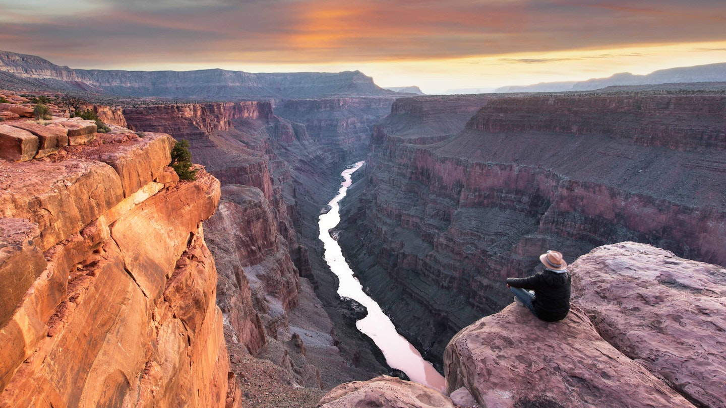 A hiker takes in the view at Toroweap Point on the North Rim of the Grand Canyon. Image by www.fischerfotografie.nl / Getty