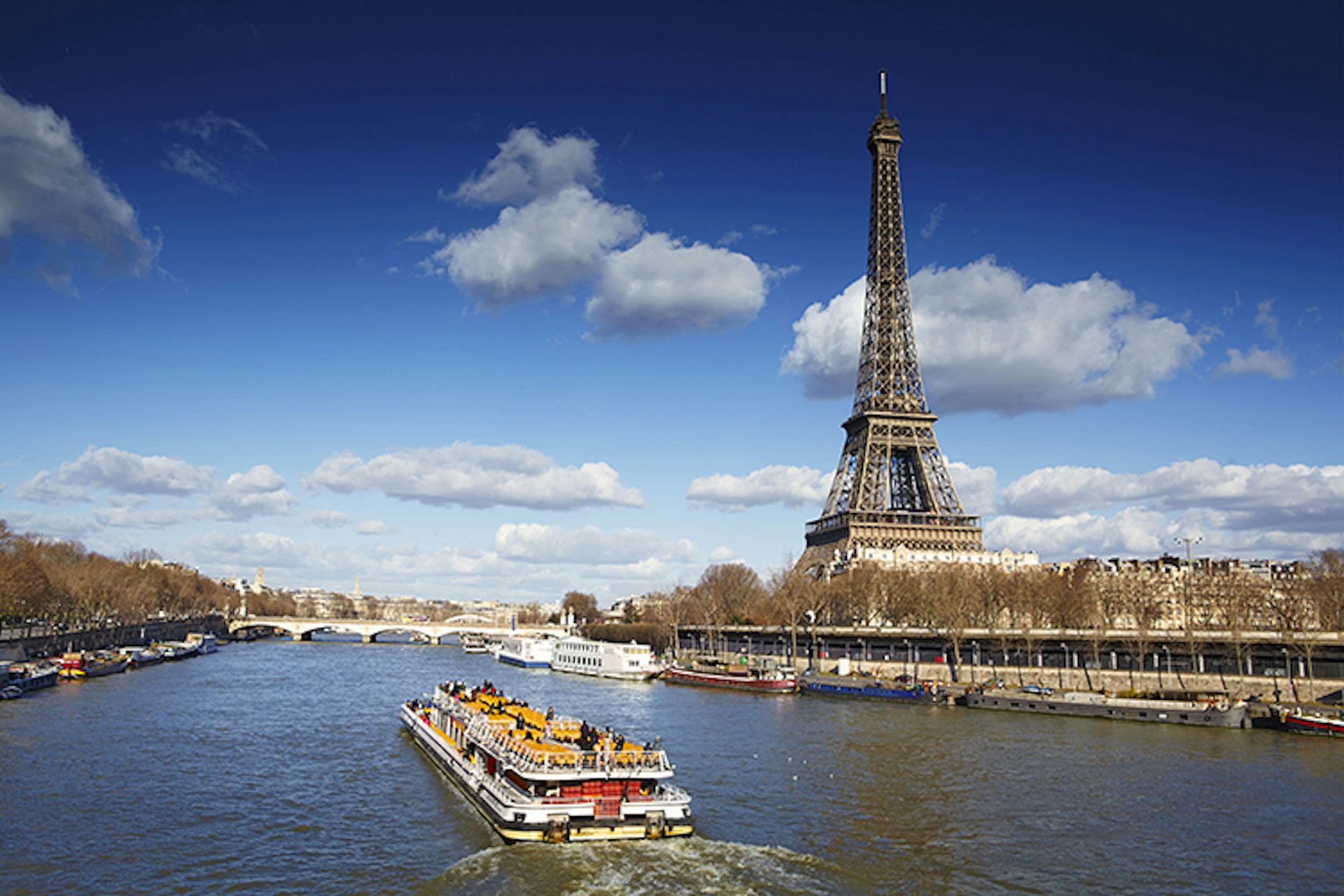 Eiffel Tower and bateau mouche on Seine River.