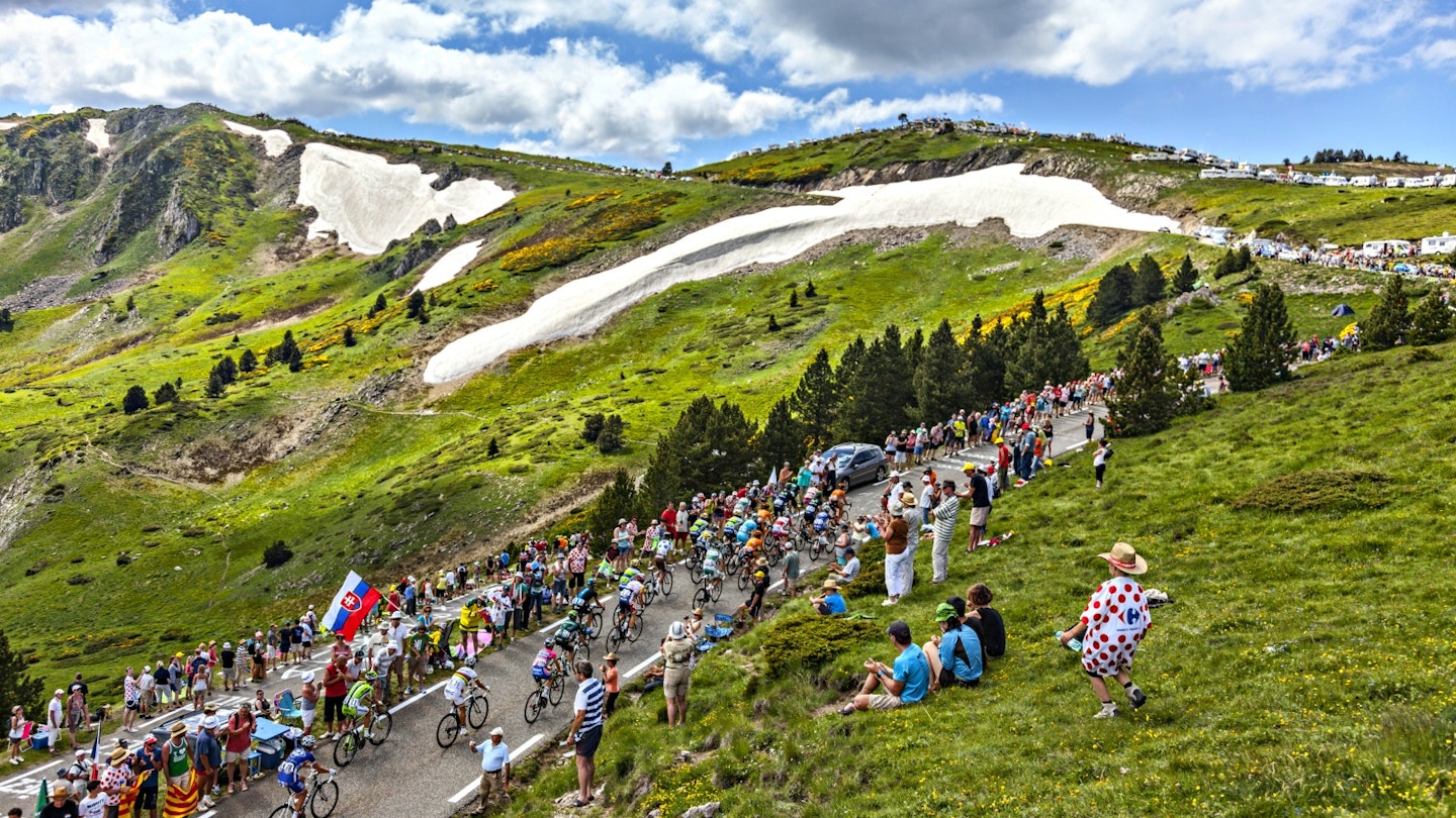 The Tour de France peloton climbs the road to Col de Pailheres