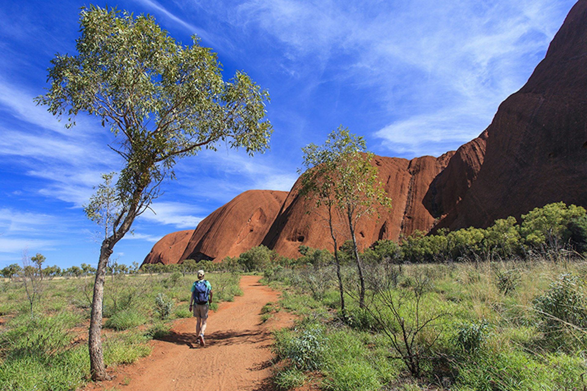 A hiker approaching the southeastern side of Uluru