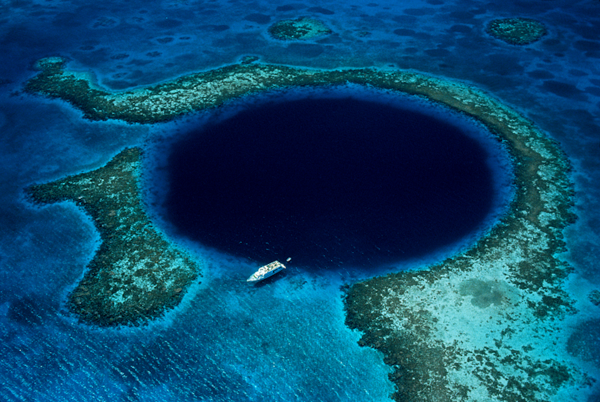 Aerial view of the Great Blue Hole. Image by Schafer & Hill / Getty Images