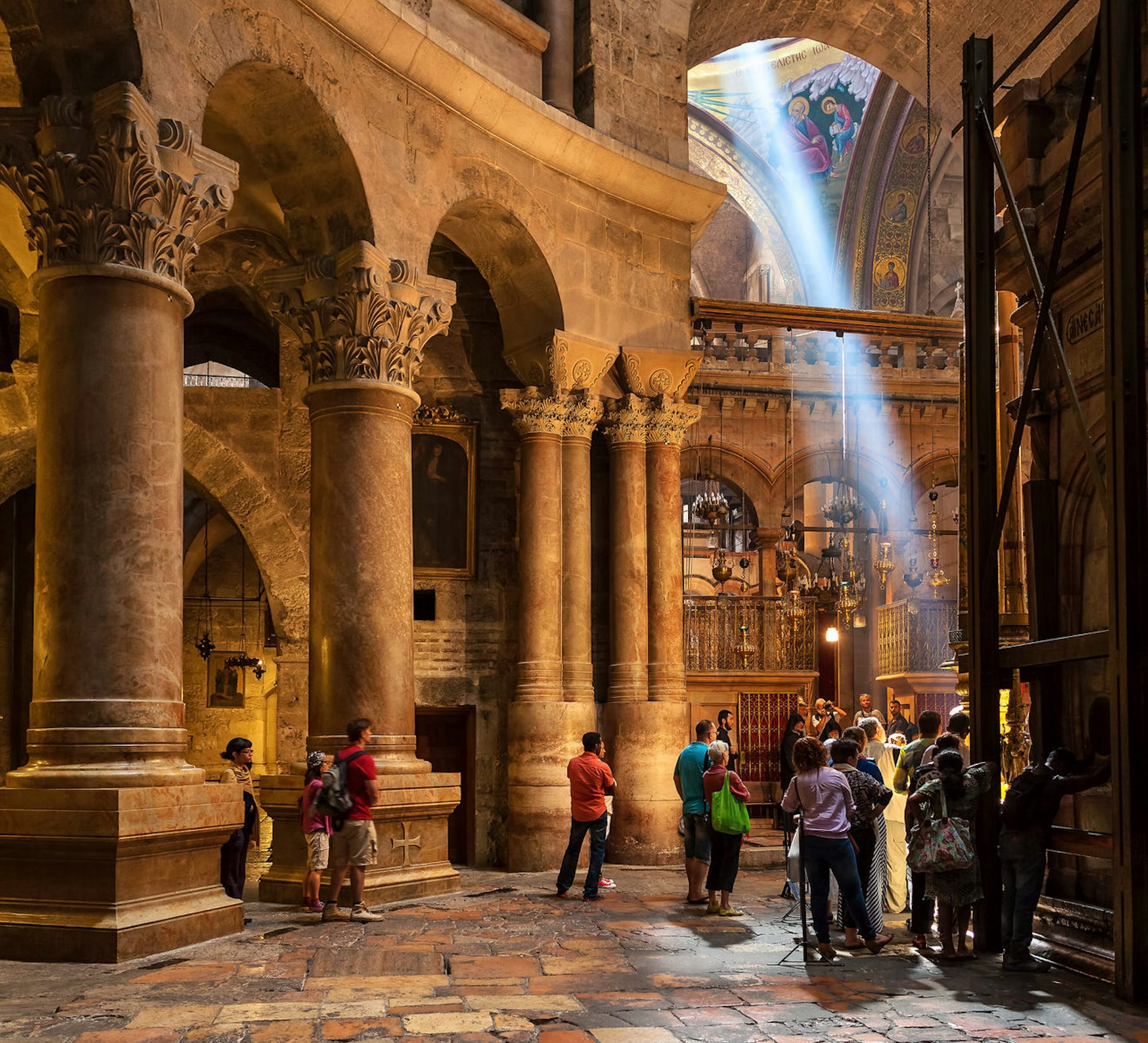 People inside Church of the Holy Sepulchre in Jerusalem, the place where according Christian tradition Jesus Christ was crucified, buried and resurrected. © Rostislav Glinsky / Shutterstock